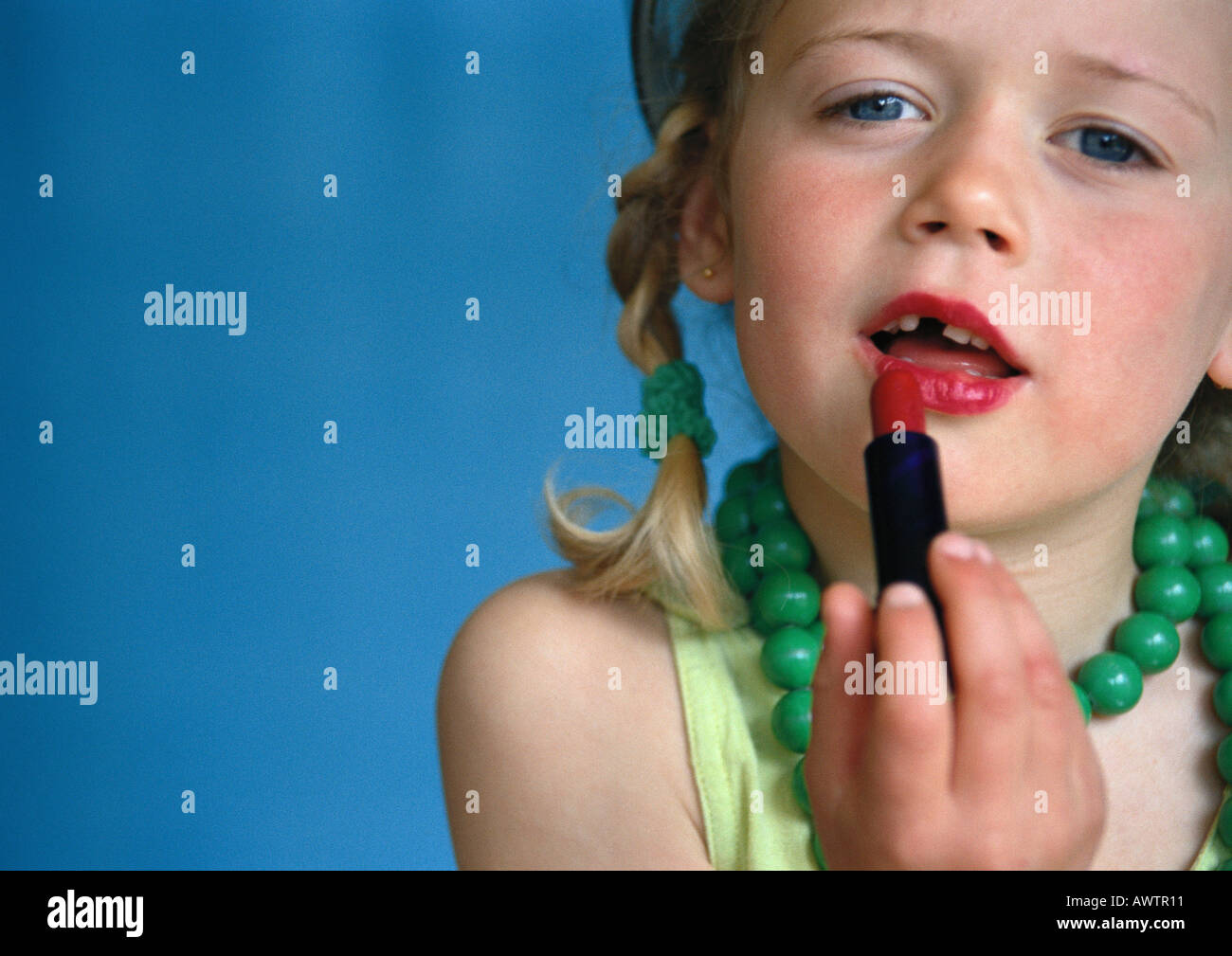 Little girl putting on lipstick, closeup Stock Photo Alamy