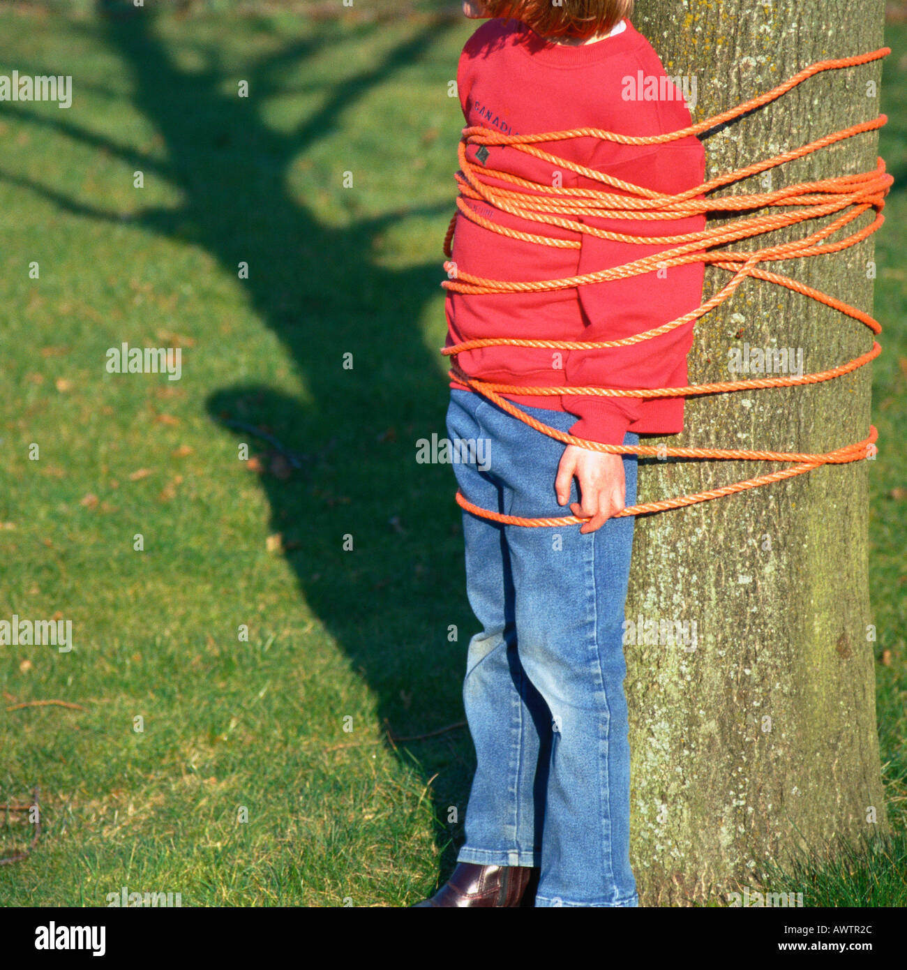 Child tied to tree, cropped Stock Photo - Alamy