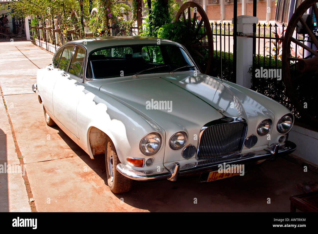 Laos Vientiane city centre Mark 10 Jaguar parked in house compound Stock Photo