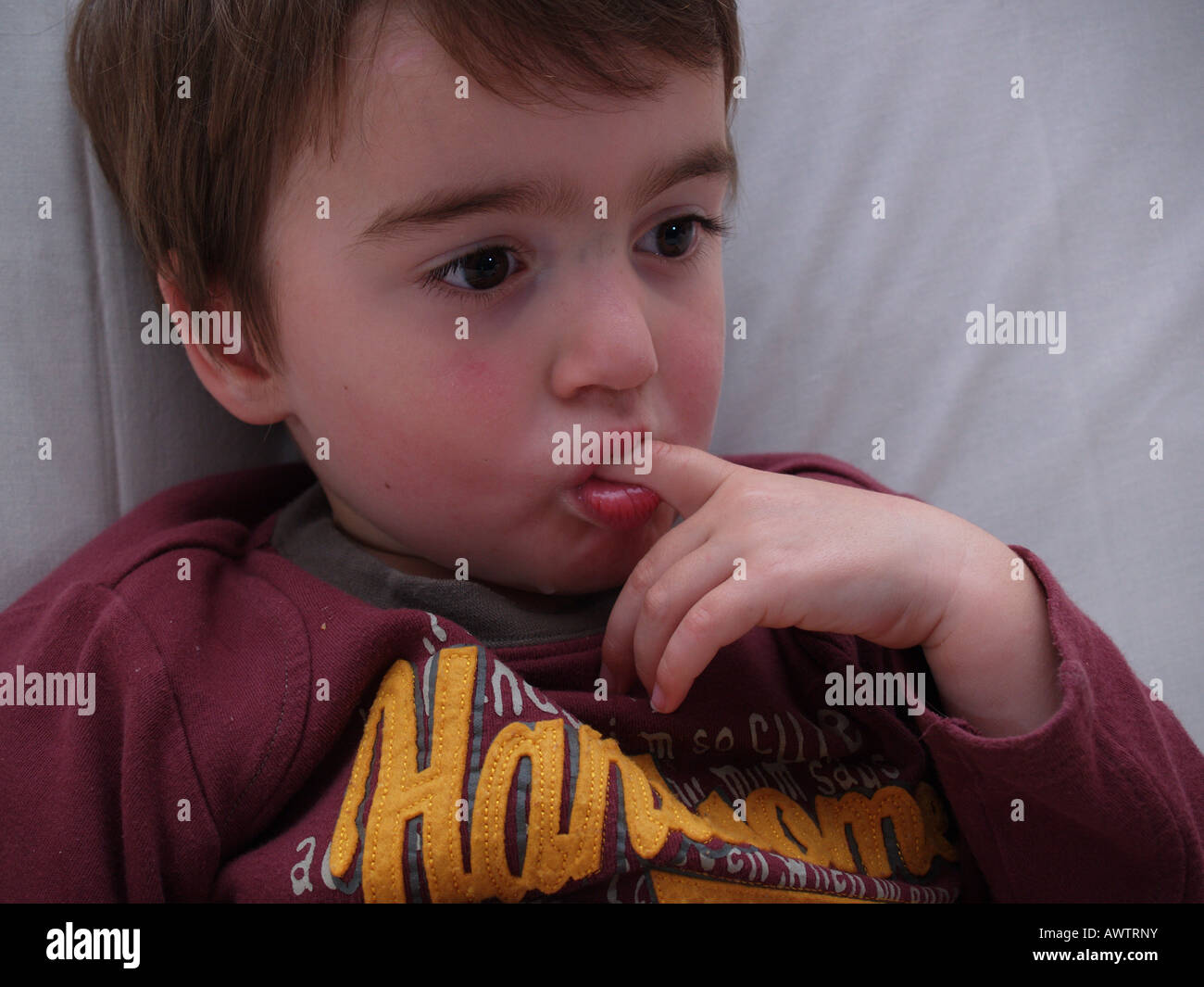 quiet looking toddler hand arm fingers mouth Stock Photo Alamy