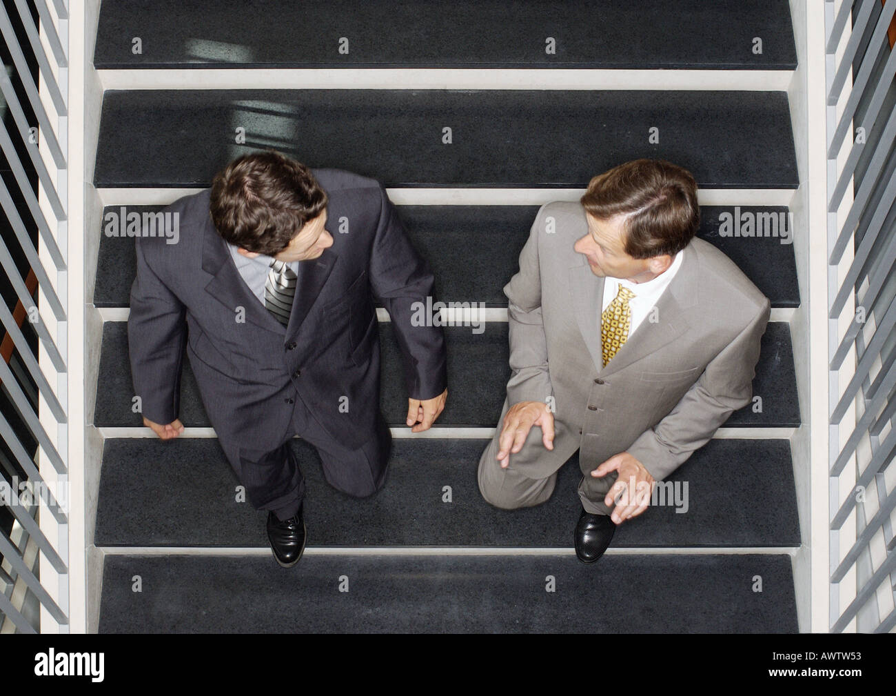 Two businessmen going down stairs, elevated view Stock Photo