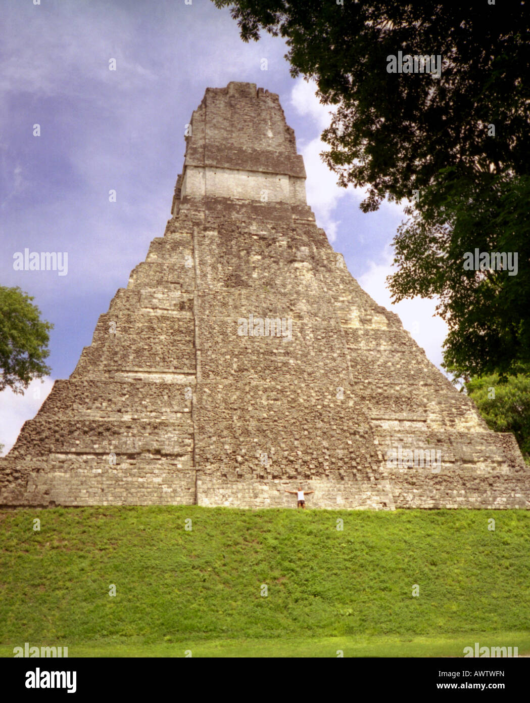 Panoramic view imposing Maya stone pyramid man standing Guatemala Central Latin America Stock Photo