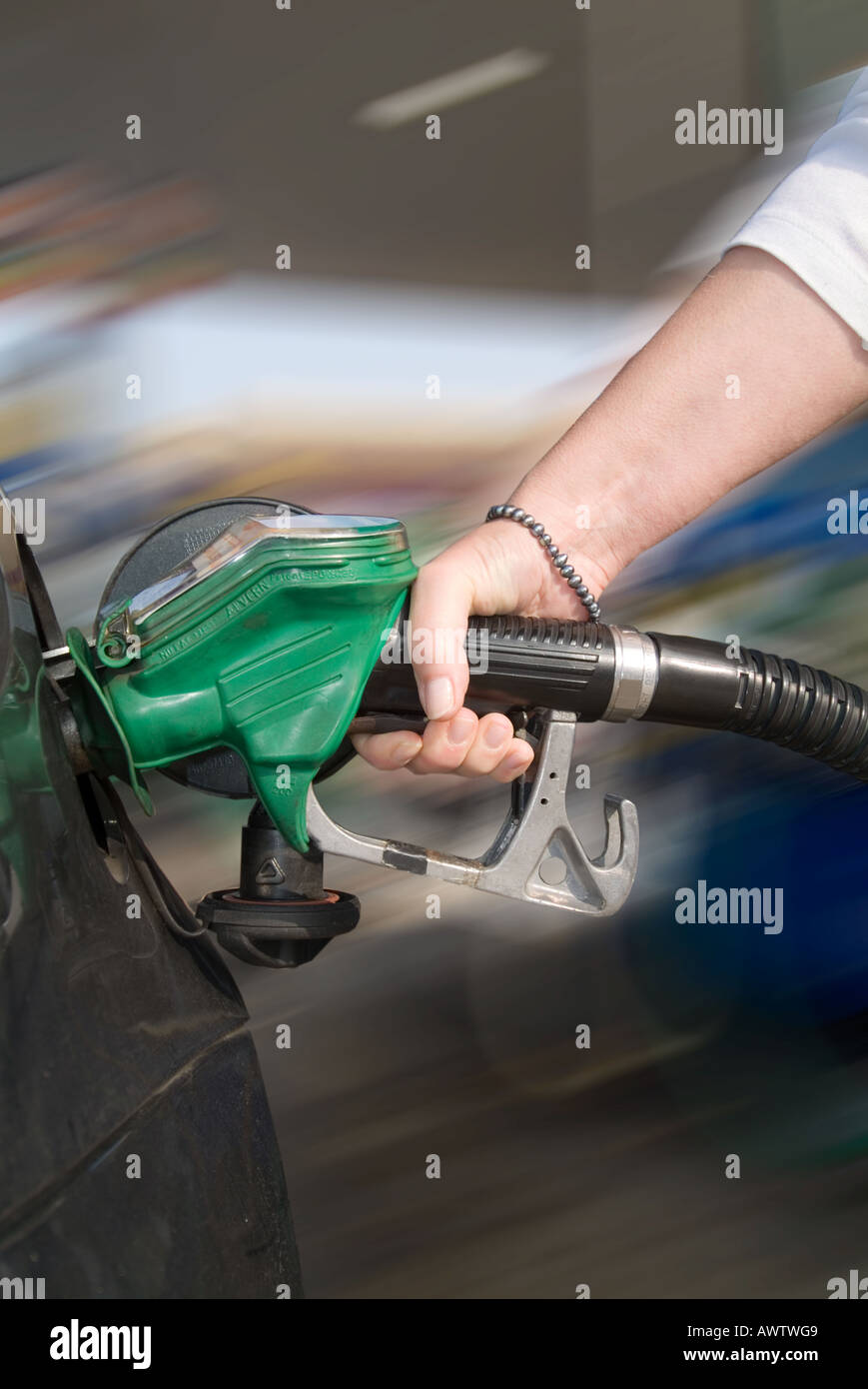 close up of a woman filling up her car with unleaded petrol Stock Photo