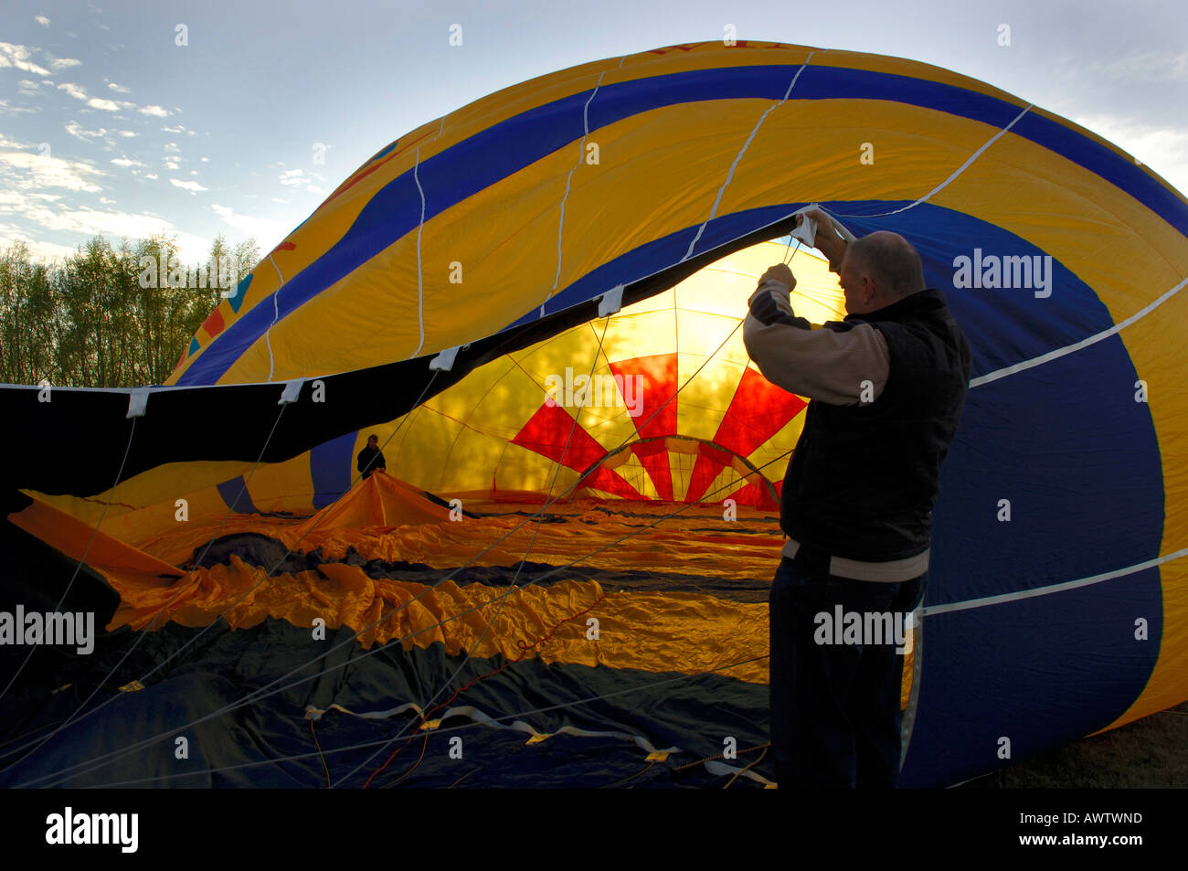 Inflating a hot air balloon with petrol powered fan Stock Photo Alamy