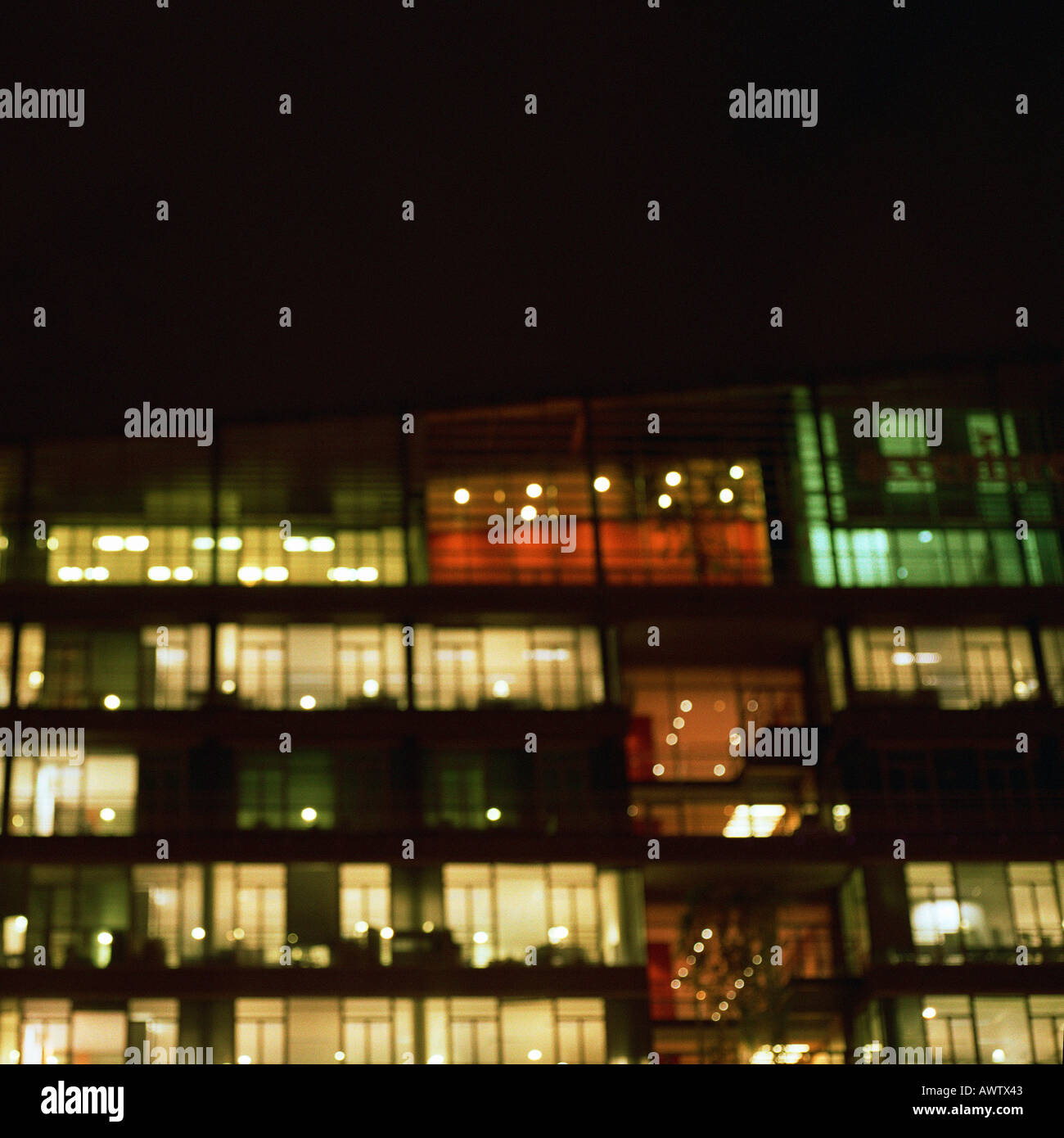 Office buildings lit up at night, exterior Stock Photo - Alamy