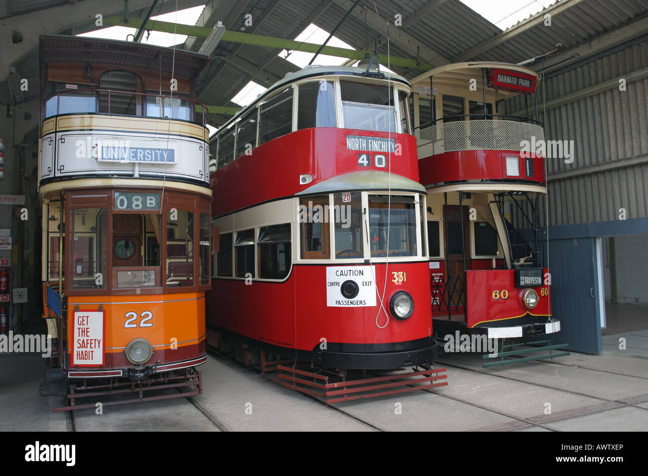 A selection of ex Glasgow (22) London (331) and Johannesburg (60) trams in the tramshed at Crich Tramway Museum, Derbyshire UK Stock Photo