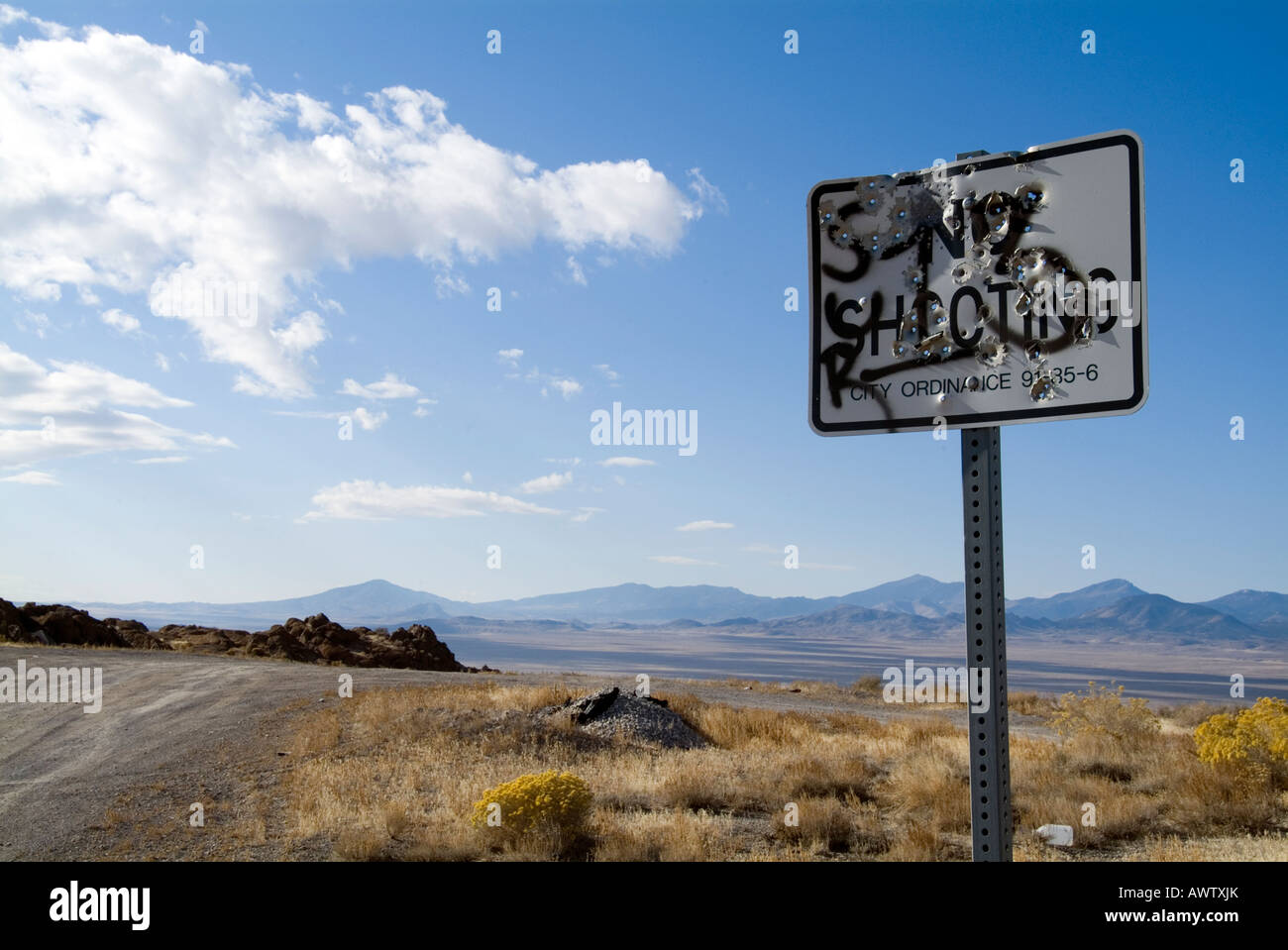 road sign in desert used for target pratice sign reads no shooting Stock Photo