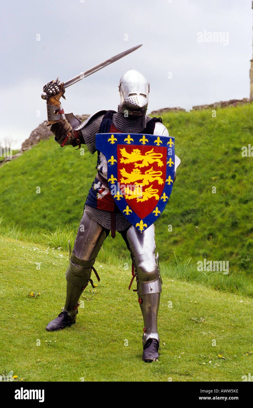 Medieval Knight in Plate Armour sword shield re enactment history costume historical coat of arms three 3 lions lion English UK Stock Photo