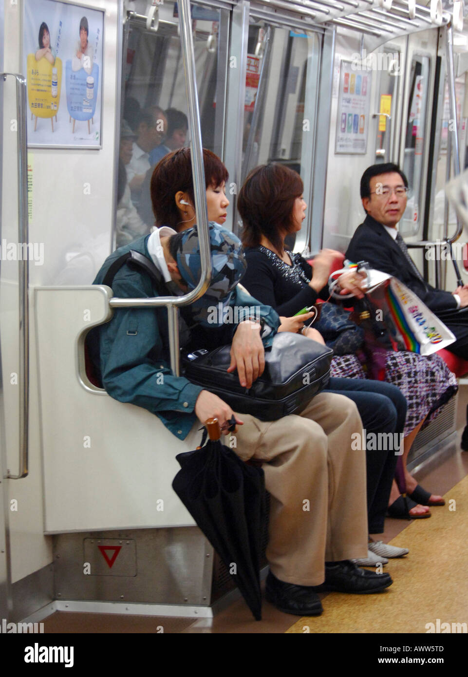 Passengers on Tokyo subway train Stock Photo
