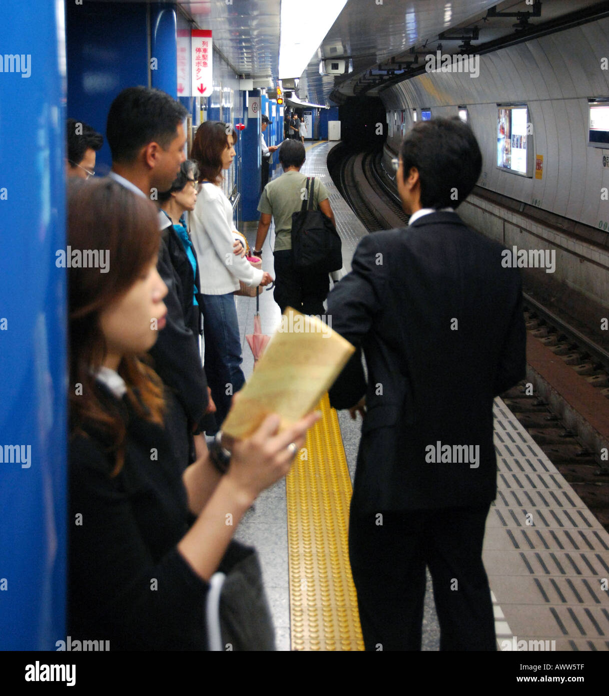 Businessmen waiting for subway train, Tokyo Japan Stock Photo