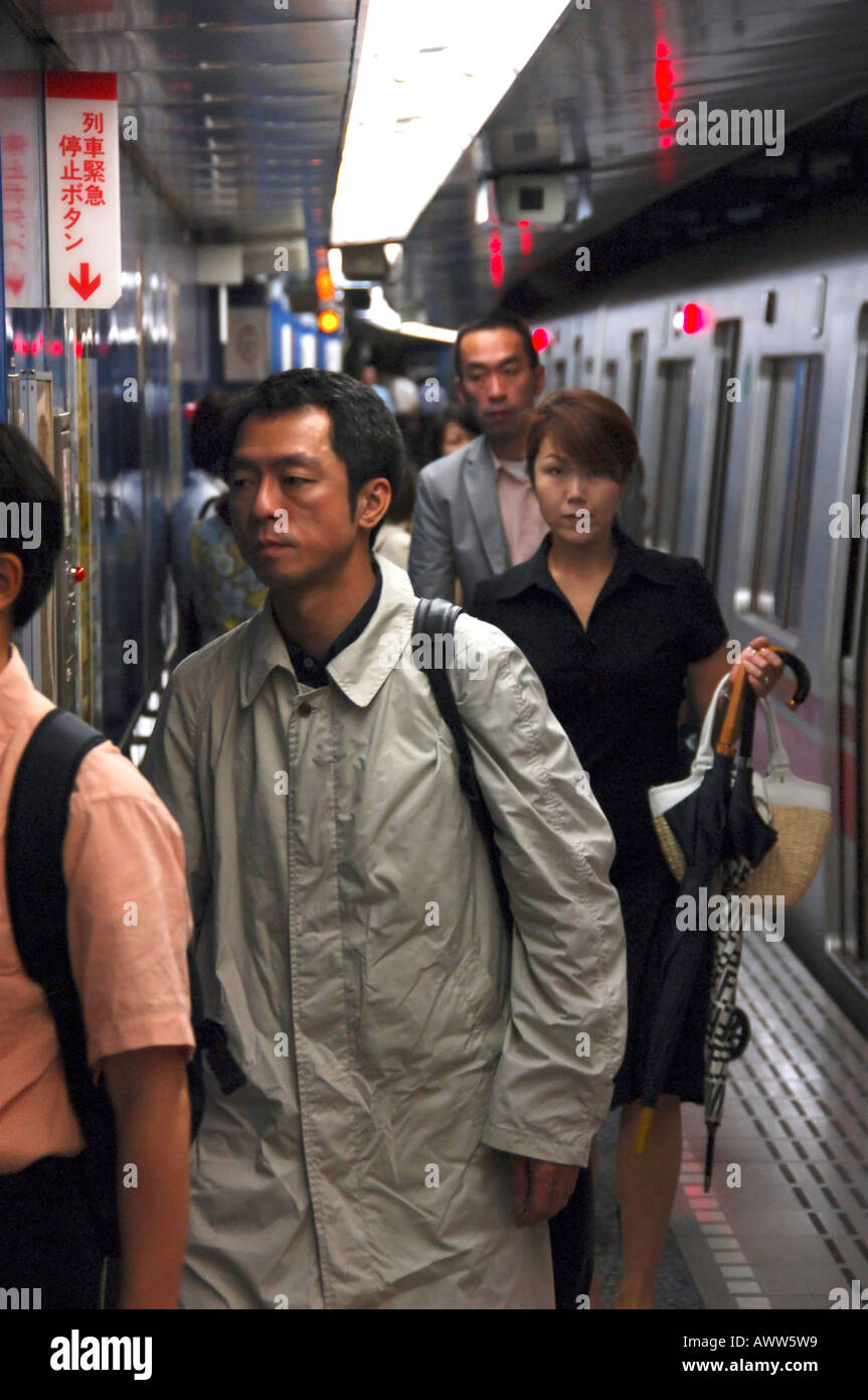Passengers leaving a Tokyo subway train, Tokyo Japan Stock Photo