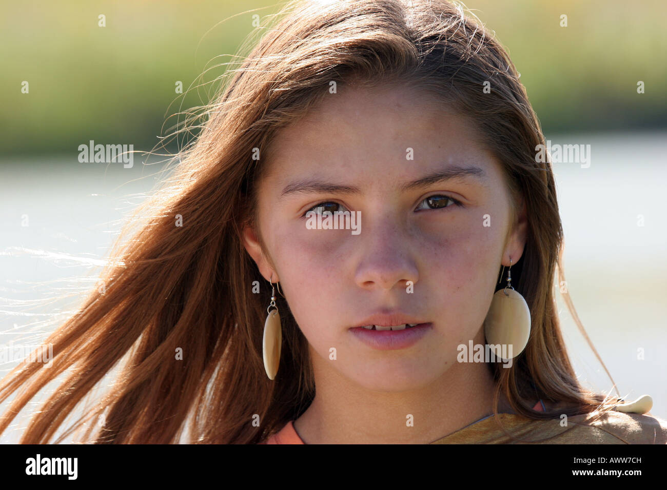 A young Native American Indian teenager girl walking along a rivers edge in South Dakota Stock Photo