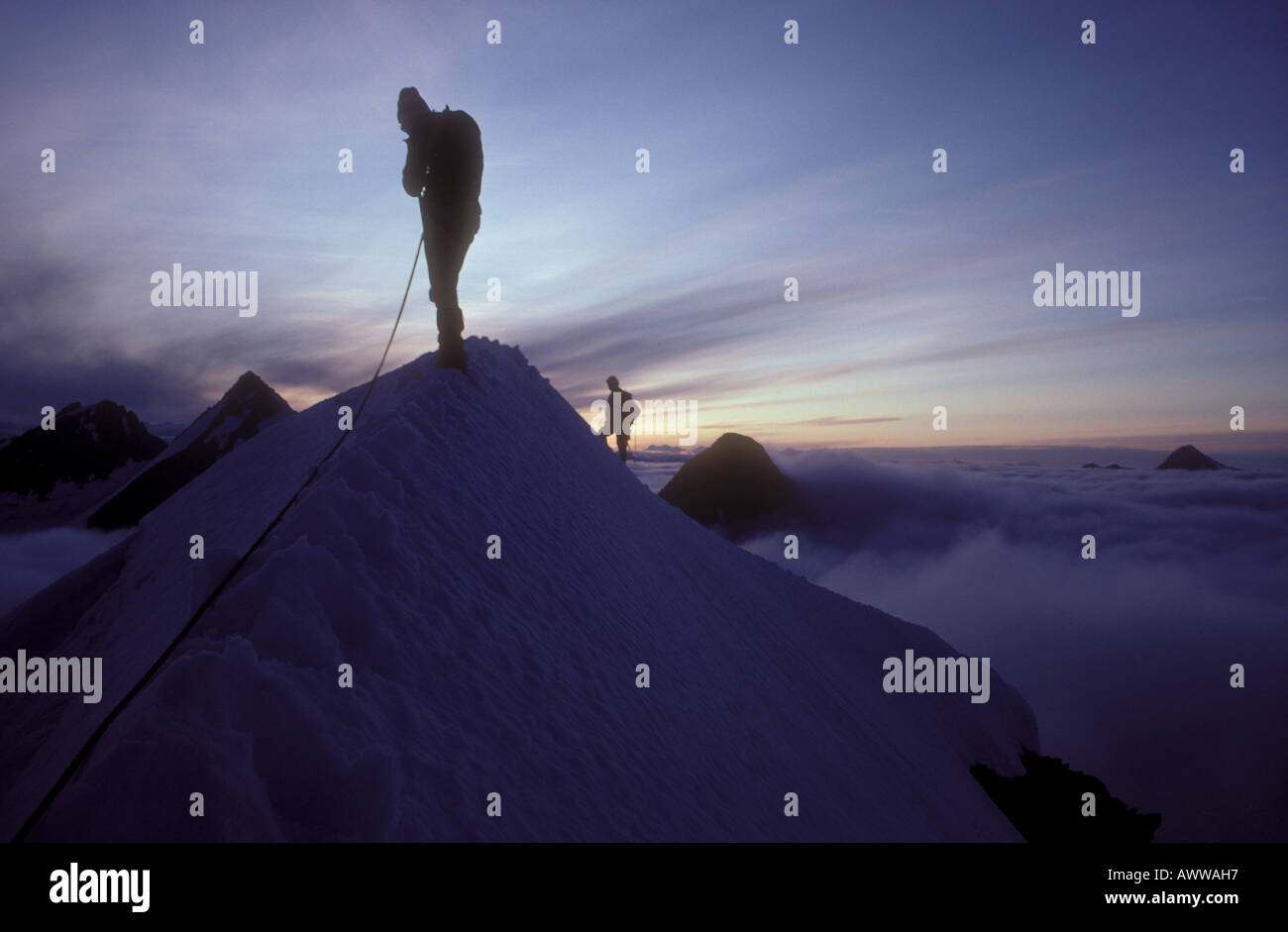 Mountain climbers silhoutted on snow ridge, Alaska Stock Photo