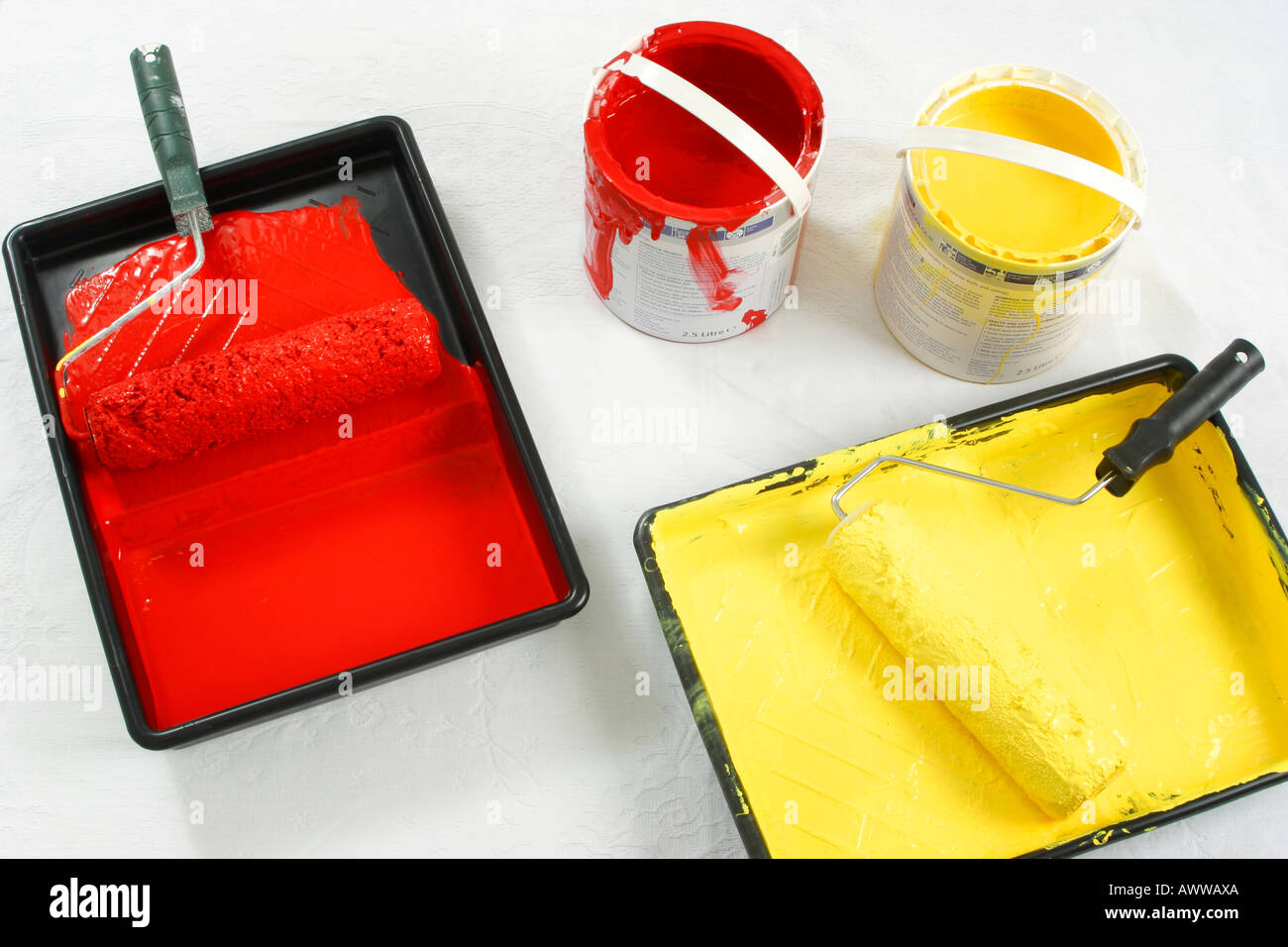 Paint rollers in paint trays and open tins of paint Stock Photo Alamy