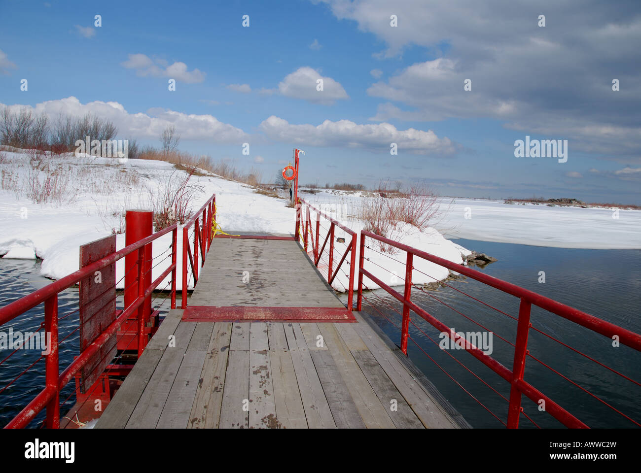 A red pedestrian bridge crossing a channel on the Leslie spit in Toronto. Stock Photo