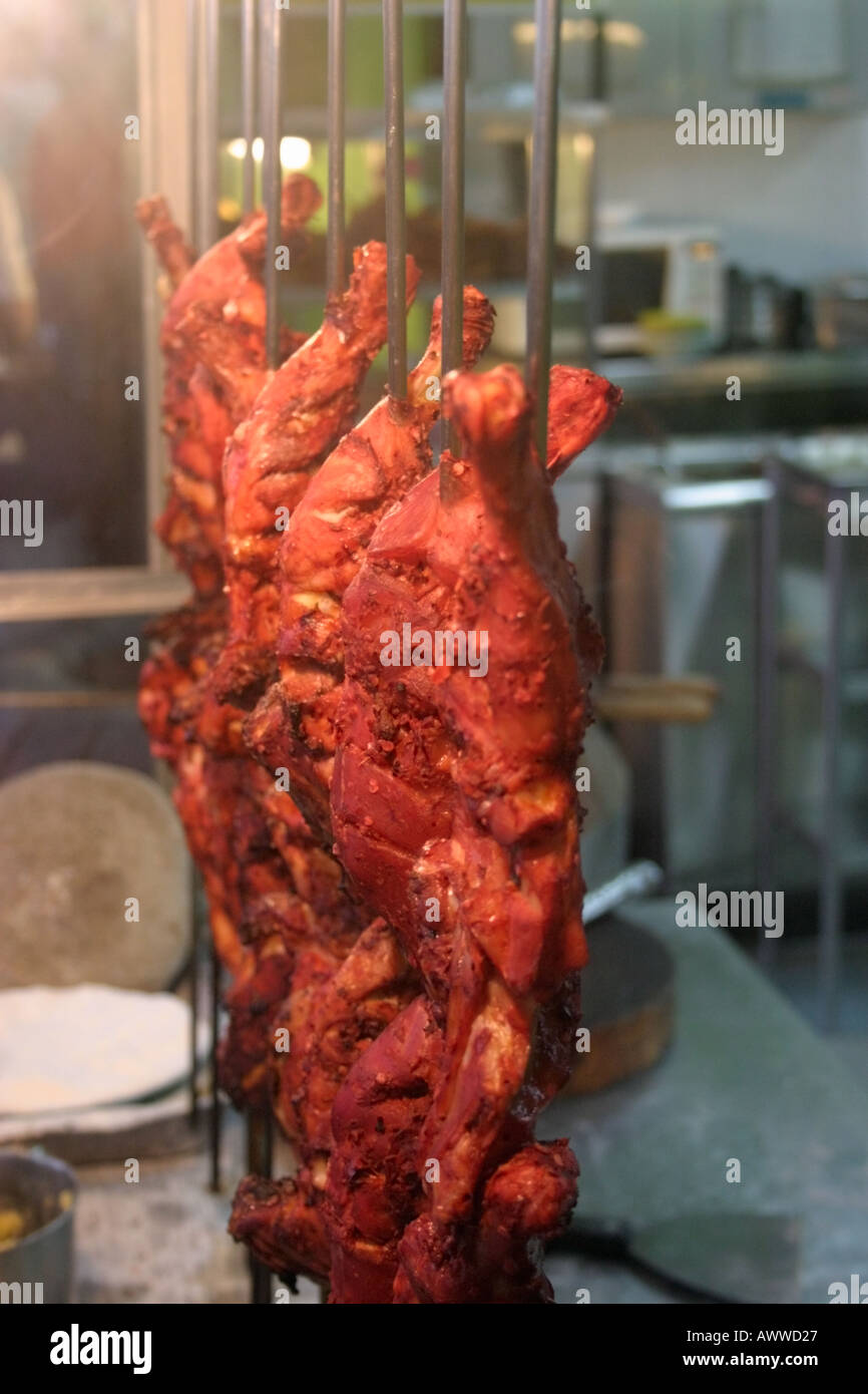 tandoori chicken hanging on display behind glass cabinet at an Indian  restaurant in Malaysia Stock Photo - Alamy