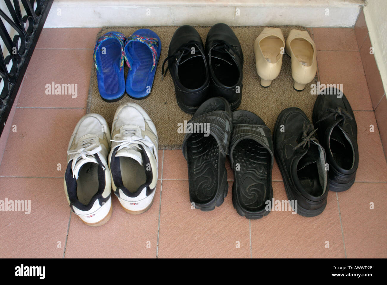 shoes on doormat outside asian household door neatly arranged Stock Photo -  Alamy