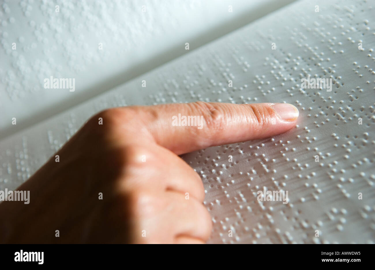 blind person reading book by touching braille with finger Stock Photo -  Alamy