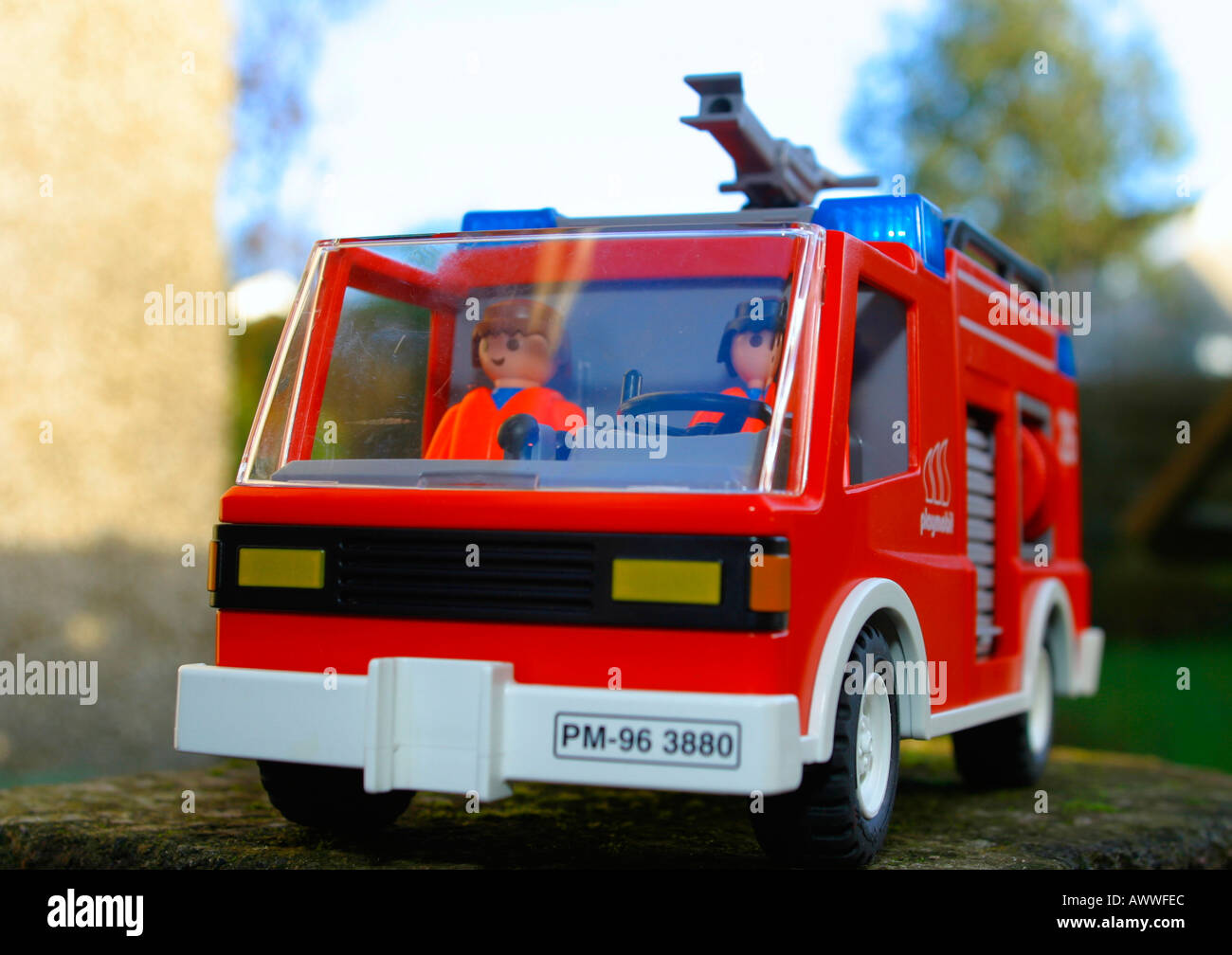 Toy fire engine with figures inside and blue light flashing Stock Photo