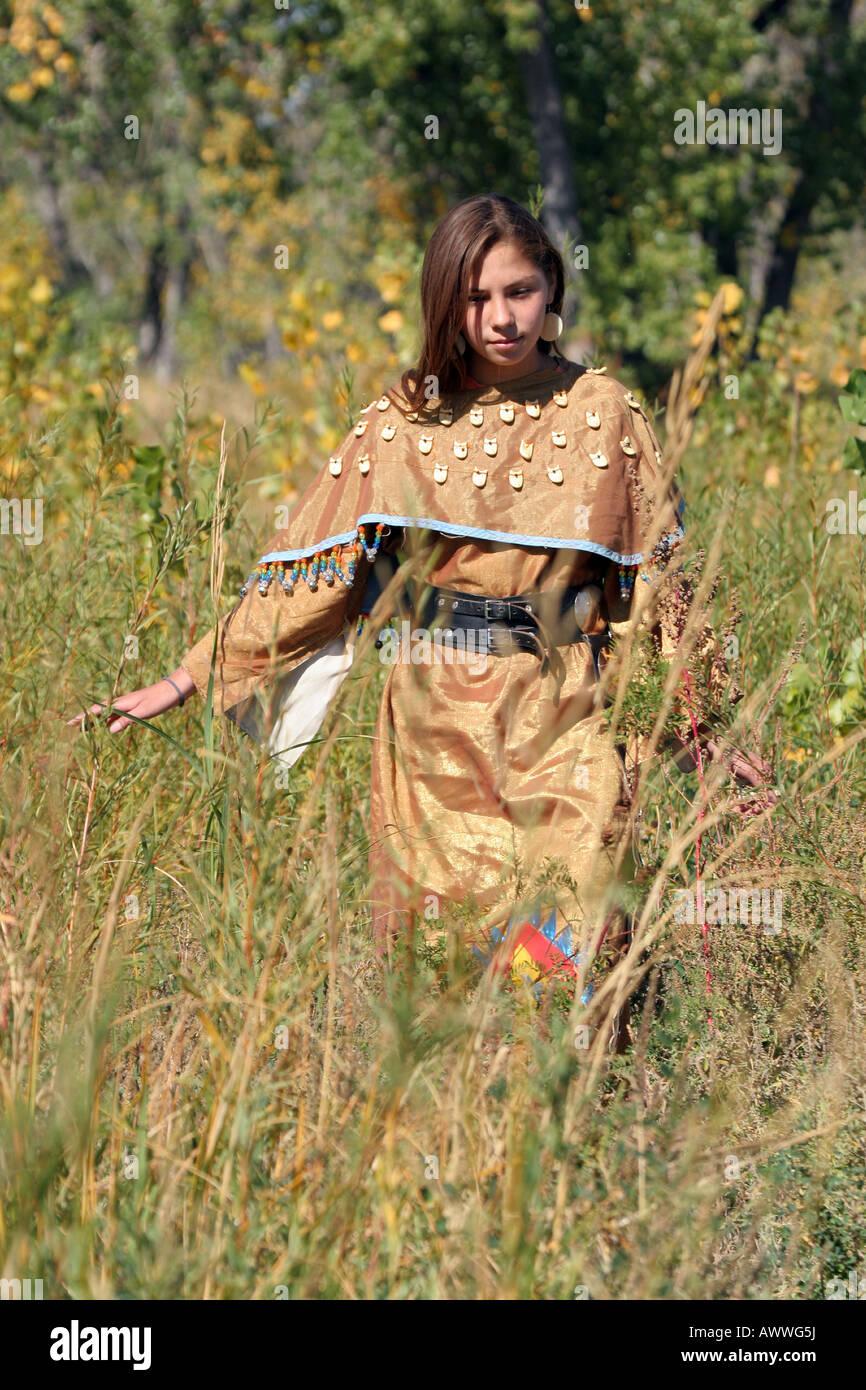 A young Native American Indian teenager girl walking along a rivers edge in South Dakota Stock Photo
