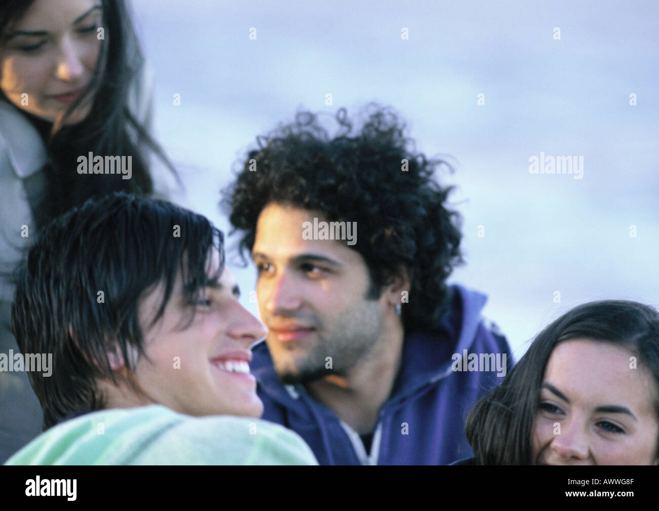 Young people sitting together, close-up Stock Photo