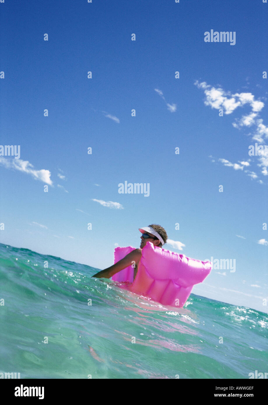 Man floating on air mattress in sea Stock Photo Alamy