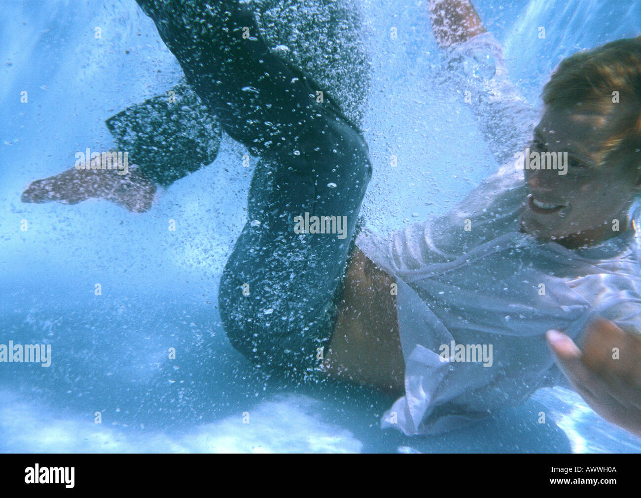 Fully clothed man at bottom of swimming pool, smiling Stock Photo - Alamy