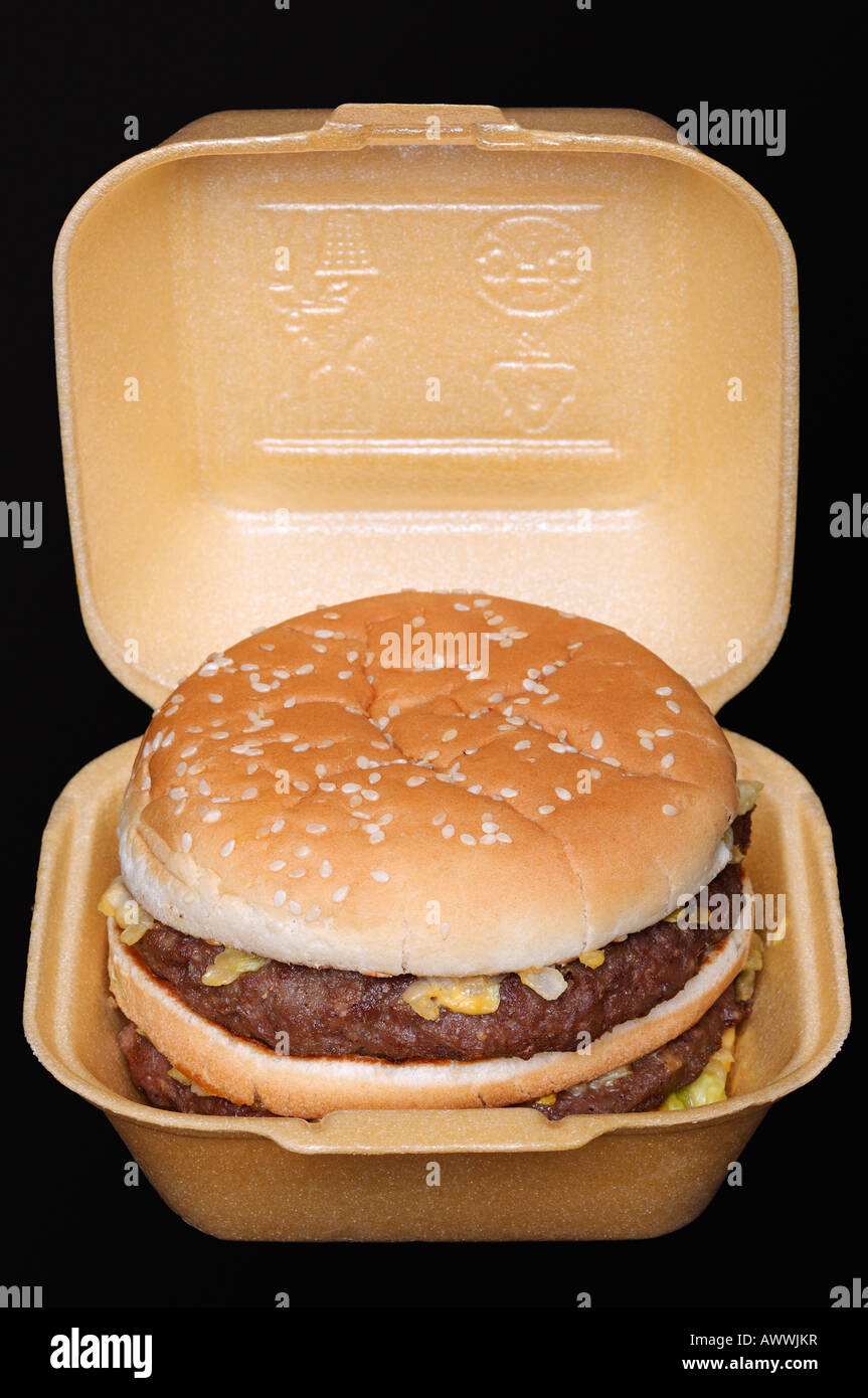 Burger in a Carton from a Fast Food Outlet, Close Up Against a Black Background Stock Photo