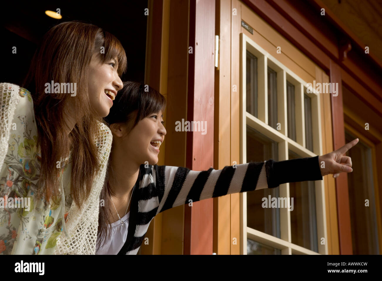 Two young women in doorway Stock Photo - Alamy