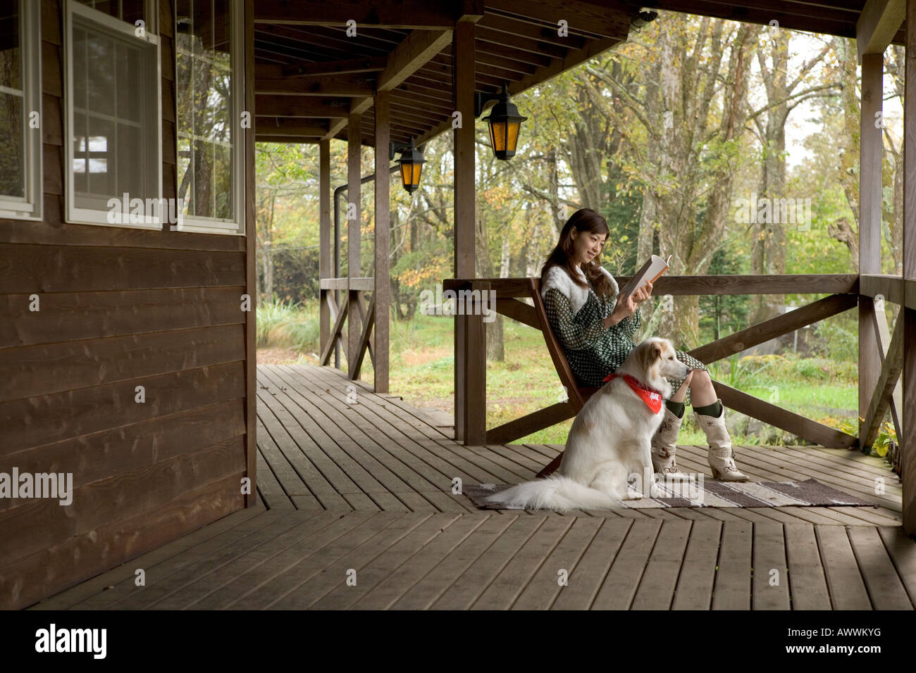Woman reading book on porch hi-res stock photography and images - Alamy