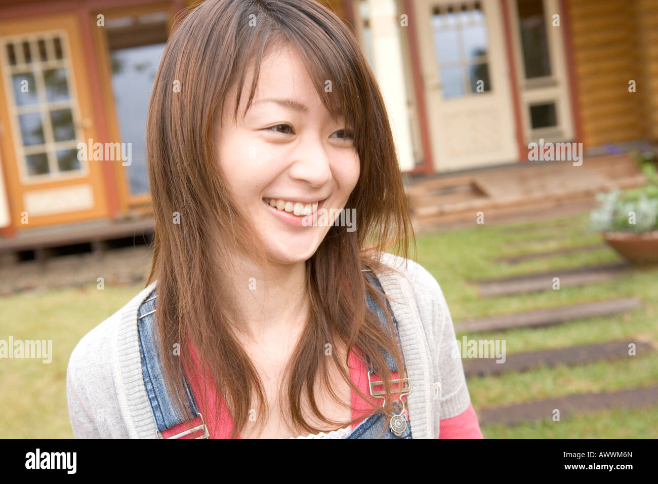 Young woman outside house Stock Photo - Alamy