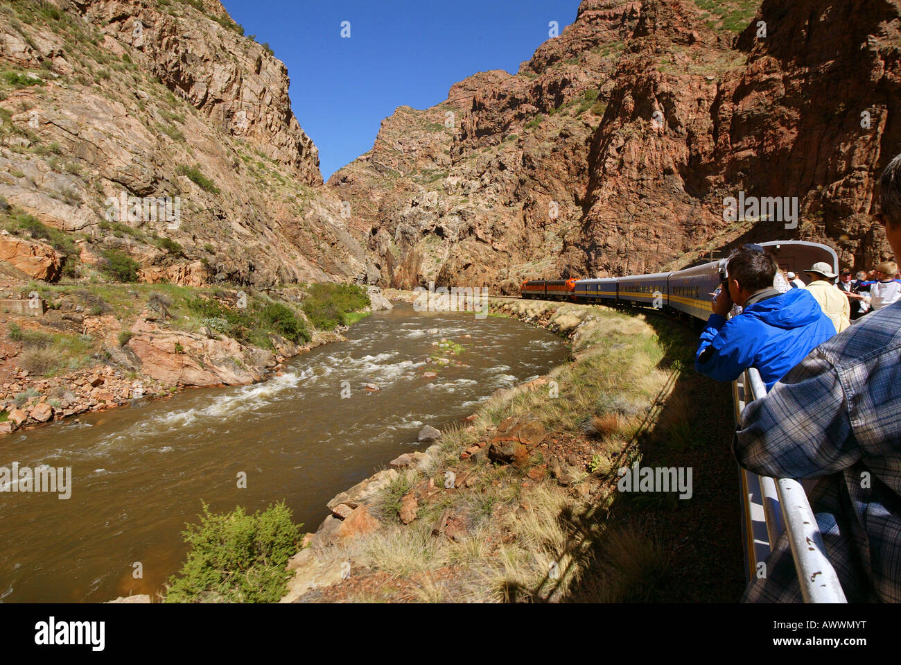 Passengers in open top car of the Royal Gorge Route Railroad view the gorge and the Arkansas River as they ride Stock Photo