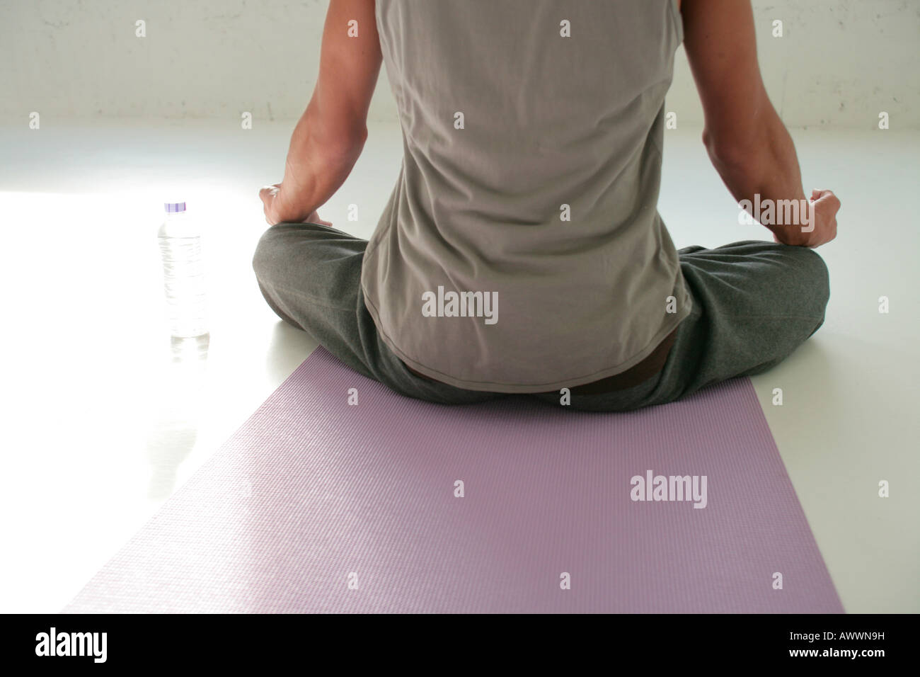 Young man meditating indoors, rear view Stock Photo - Alamy