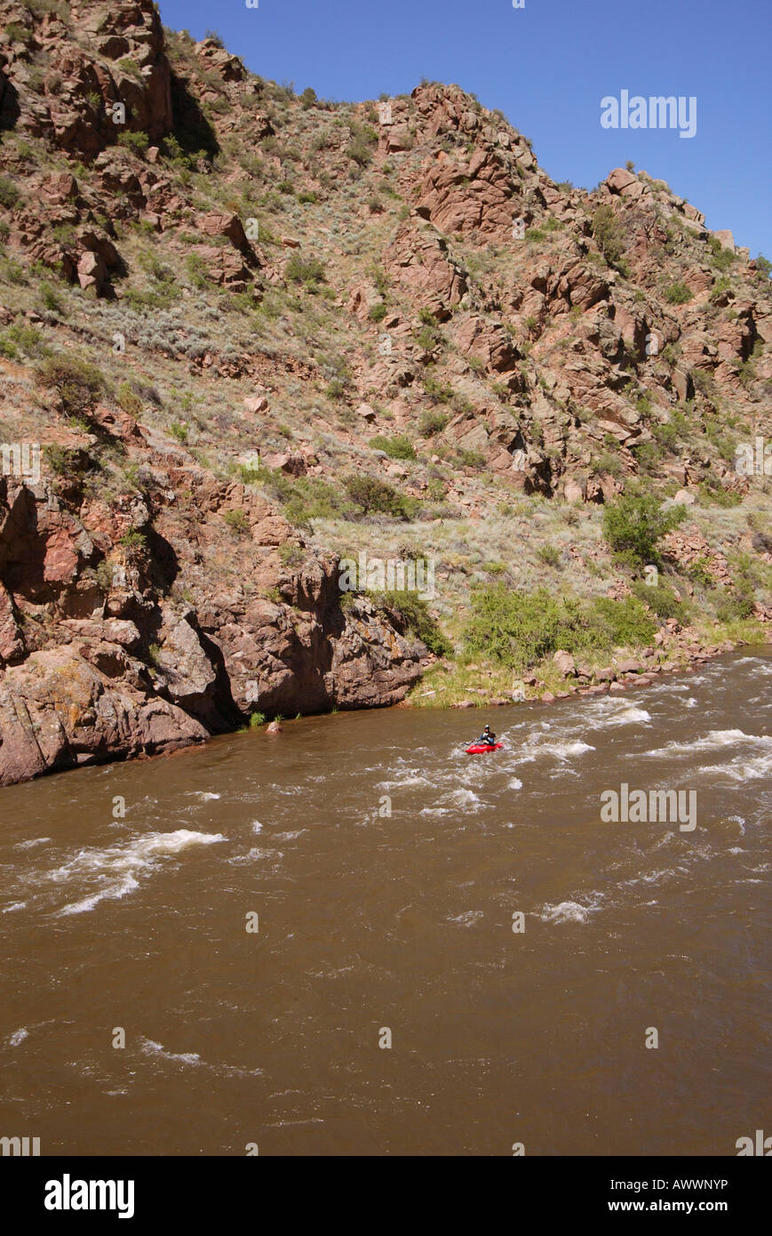 Lone mini kayaker rides down the Arkansas River as it flows through the ...