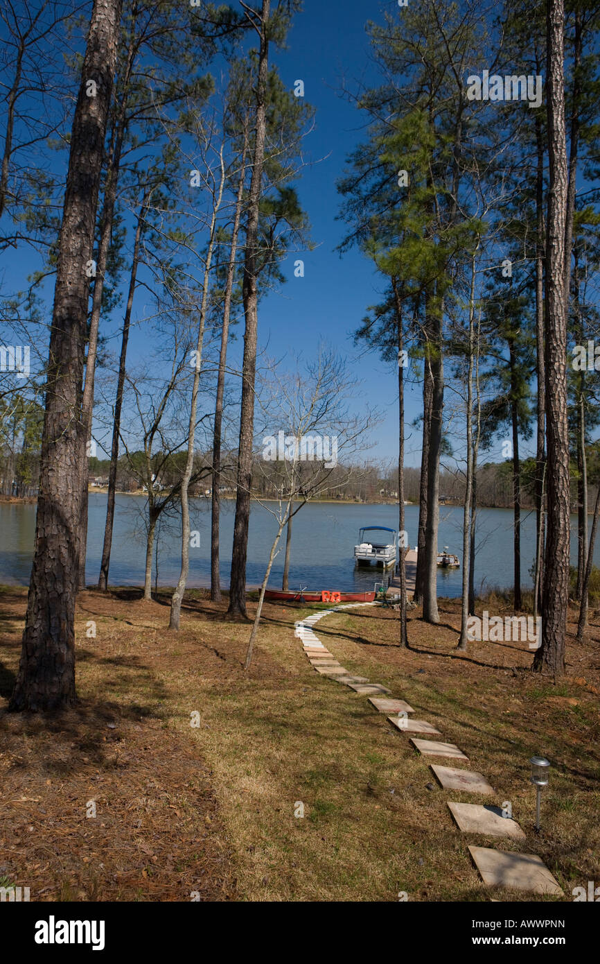 A pathway leads through pine trees to a dock on Lake Greenwood Cross Hill South Carolina United States of America Stock Photo