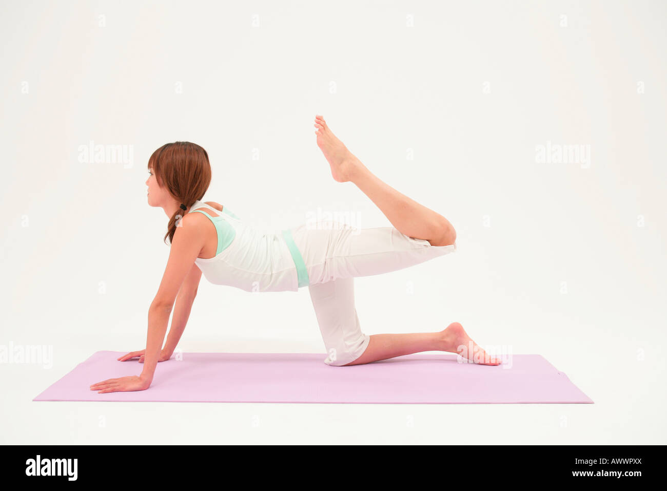 Young woman exercising on mat Stock Photo - Alamy