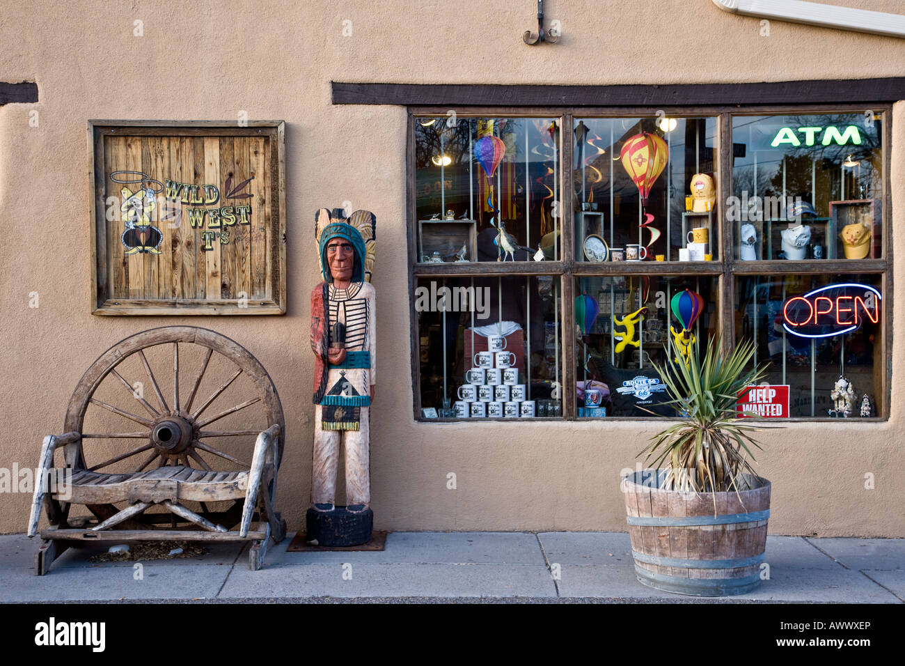Albuquerque store front with wooden Indian figure and Wagon Wheel New Mexico Stock Photo