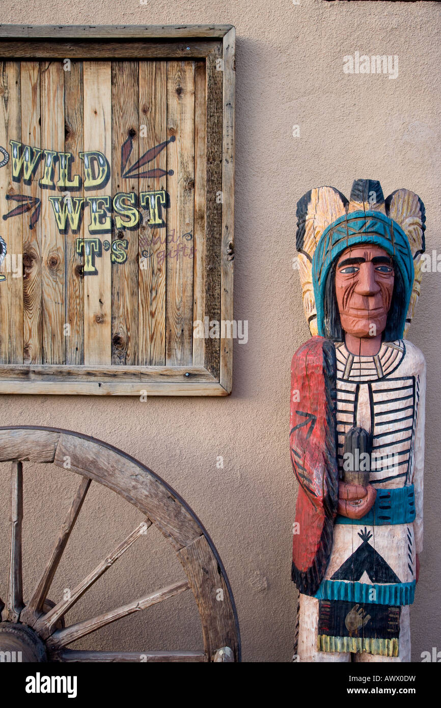 Albuquerque store front with wooden Indian figure and Wagon Wheel New Mexico Stock Photo