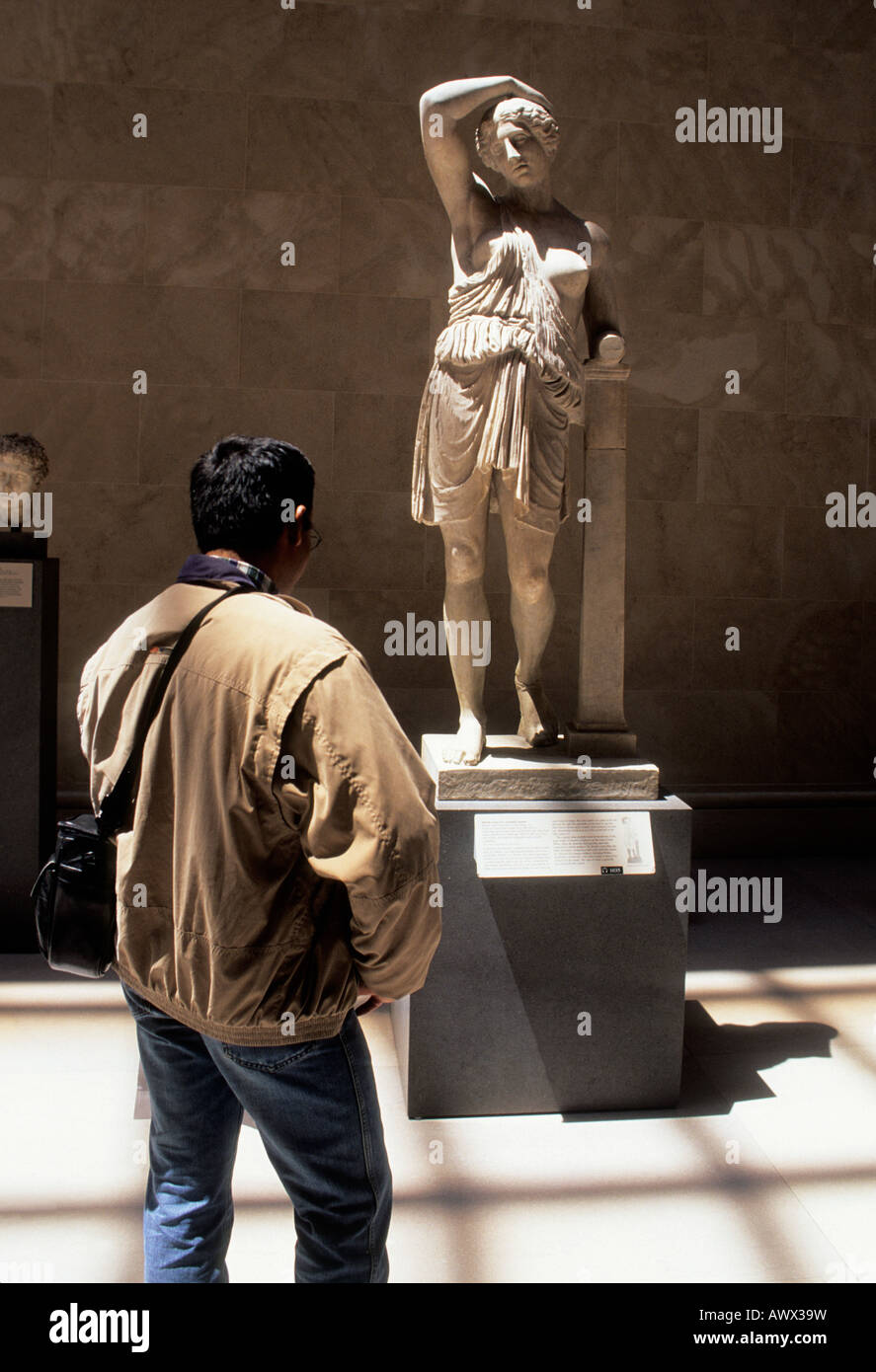 USA New York City The Metropolitan Museum of Art. Man studying a Greek