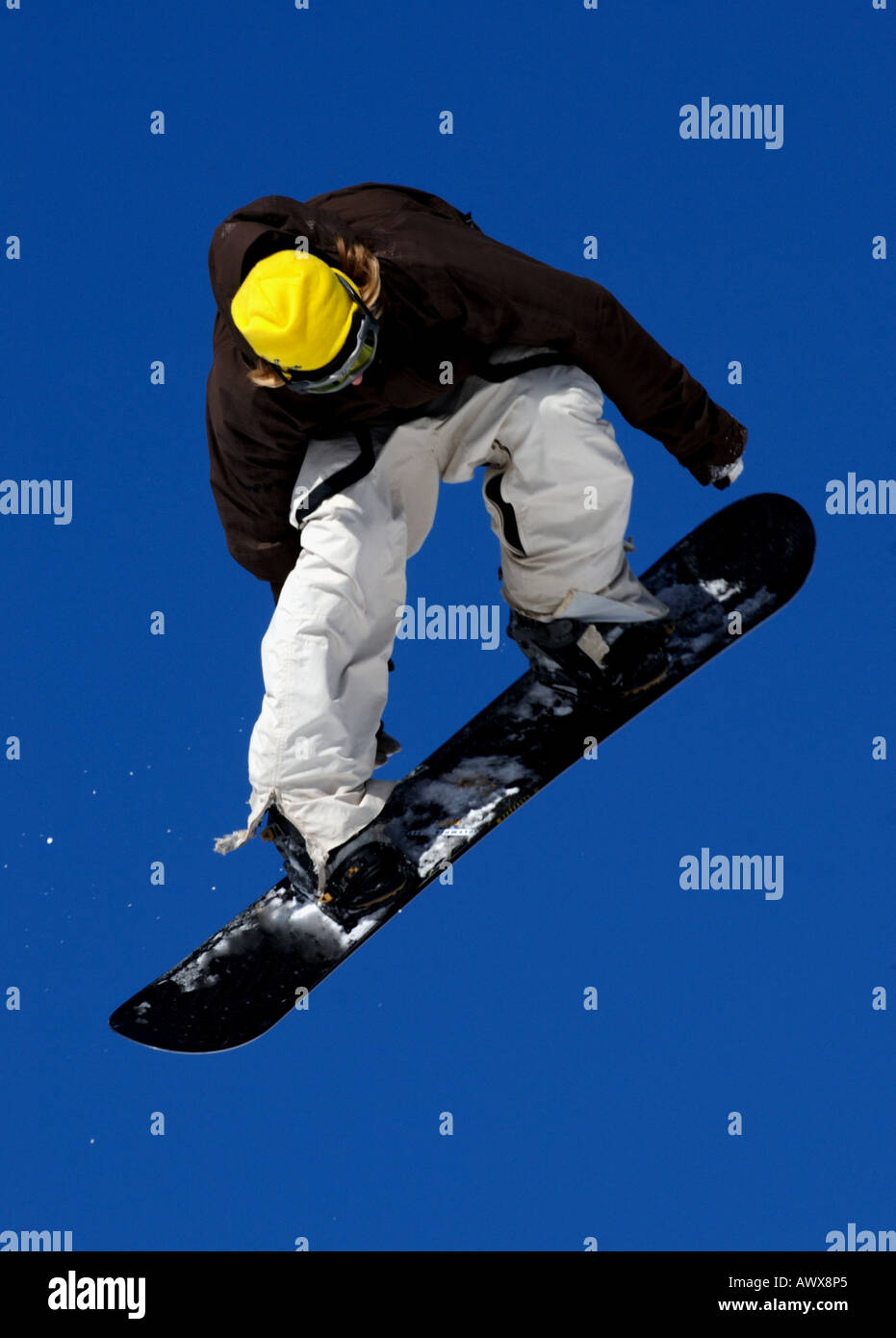 snowboarder springing against blue sky Stock Photo