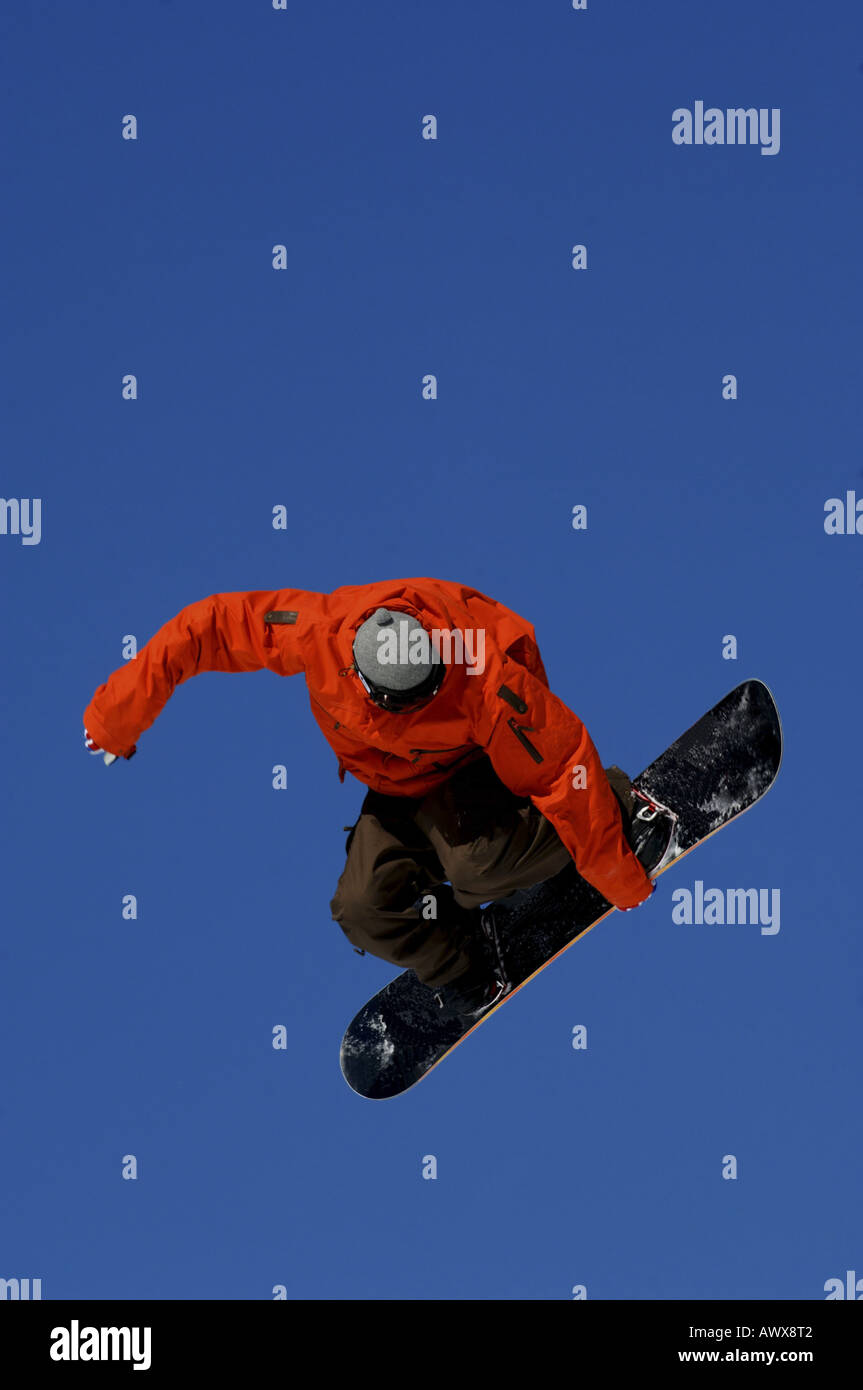 snowboarder springing against blue sky Stock Photo