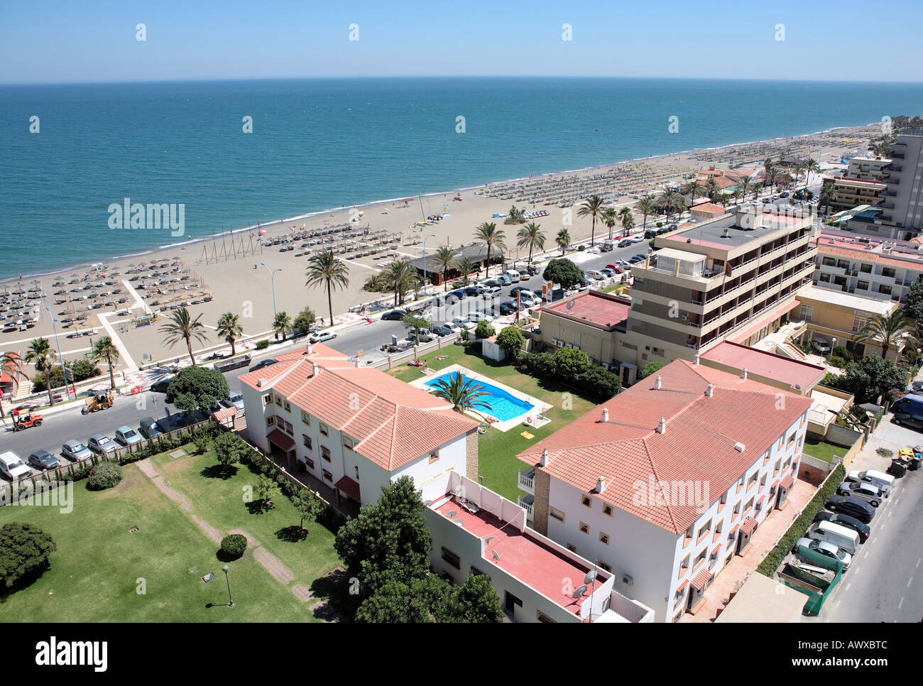Aerial view of sandy beach road buildings and holidaymakers on vacation in the sun Stock Photo