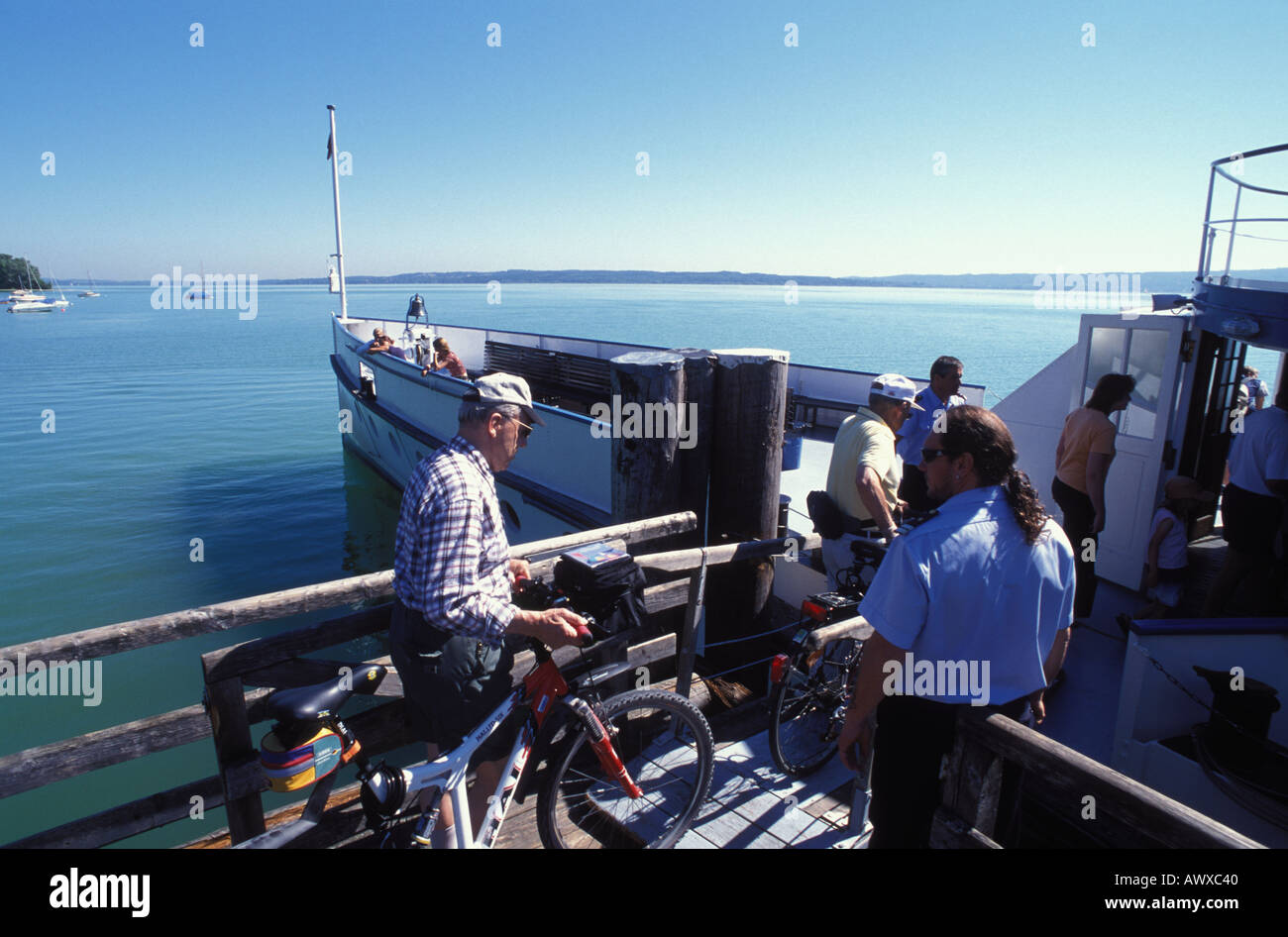 Cyclists entering paddle Steamer Diessen at Riederau Ammersee Bavaria Germany Stock Photo