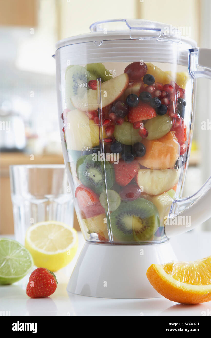 Blender filled with fresh fruits, close-up Stock Photo