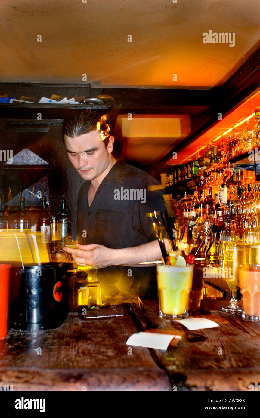 Paris France, French Bar Man 'L'Impala Lounge' Serving in a Bar 'African Restaurant' Work Cocktail Pub, night Stock Photo