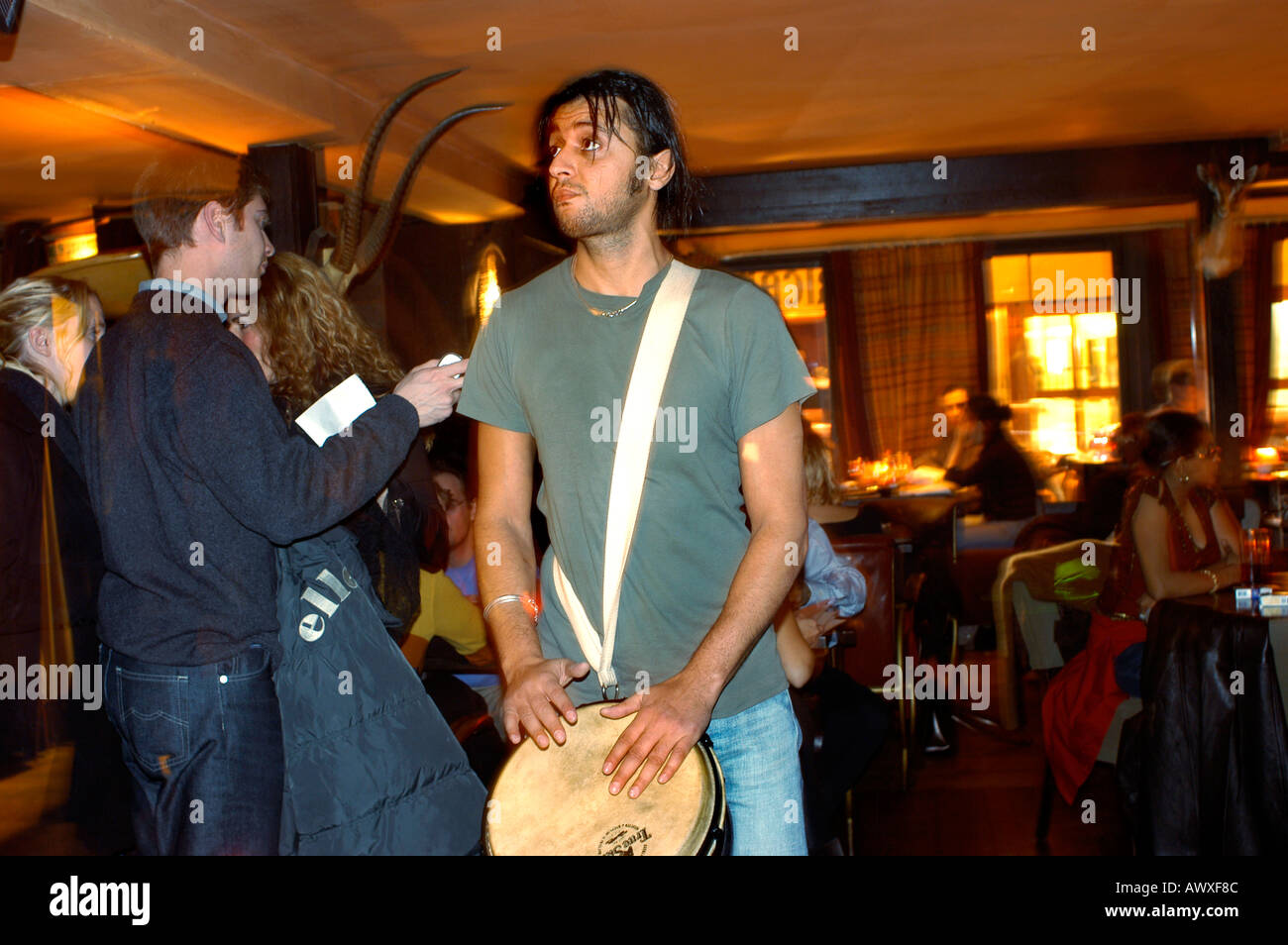 PARIS France, Teen Playing African Drum, Male Musician Drummer Playing in African Style Restaurant Bar 'L'Impala Lounge' working at night Stock Photo