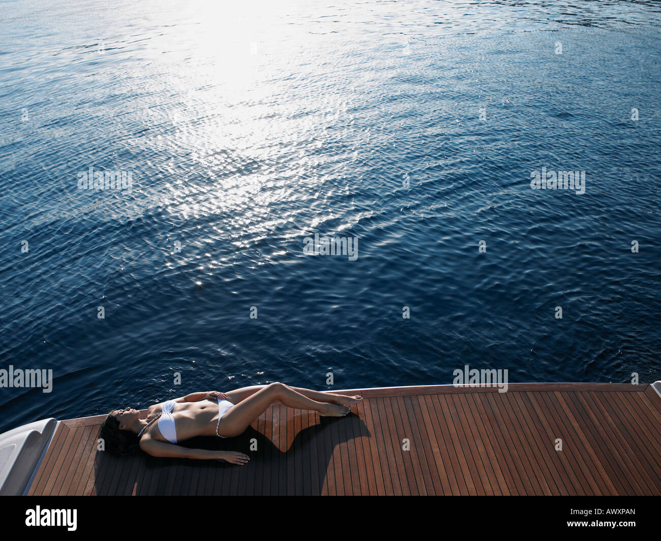 Woman Sunbathing on Yacht Stock Photo - Alamy