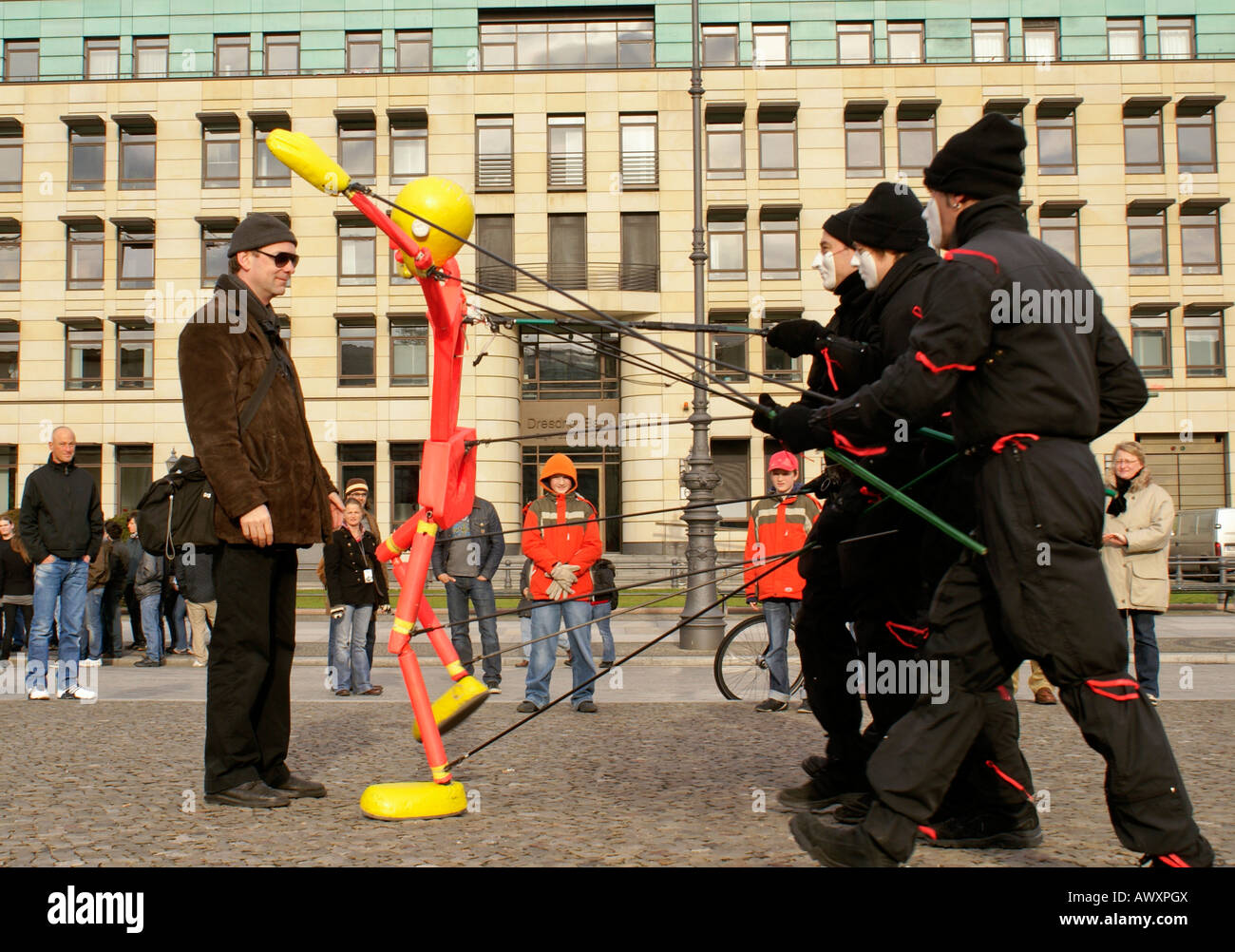 street artists in berlin manipulating a humansize puppet Stock Photo Alamy