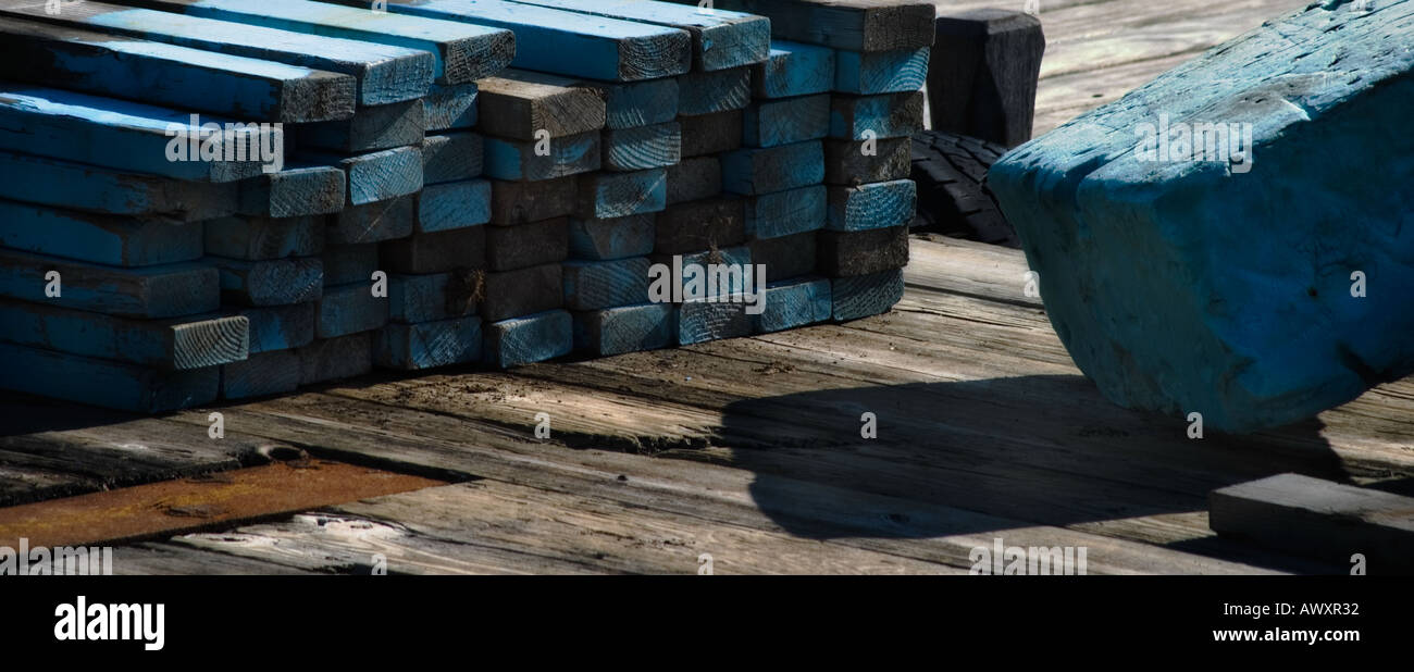 lumber and concrete painted blue sitting on a wooden dock or pier at a marina Stock Photo