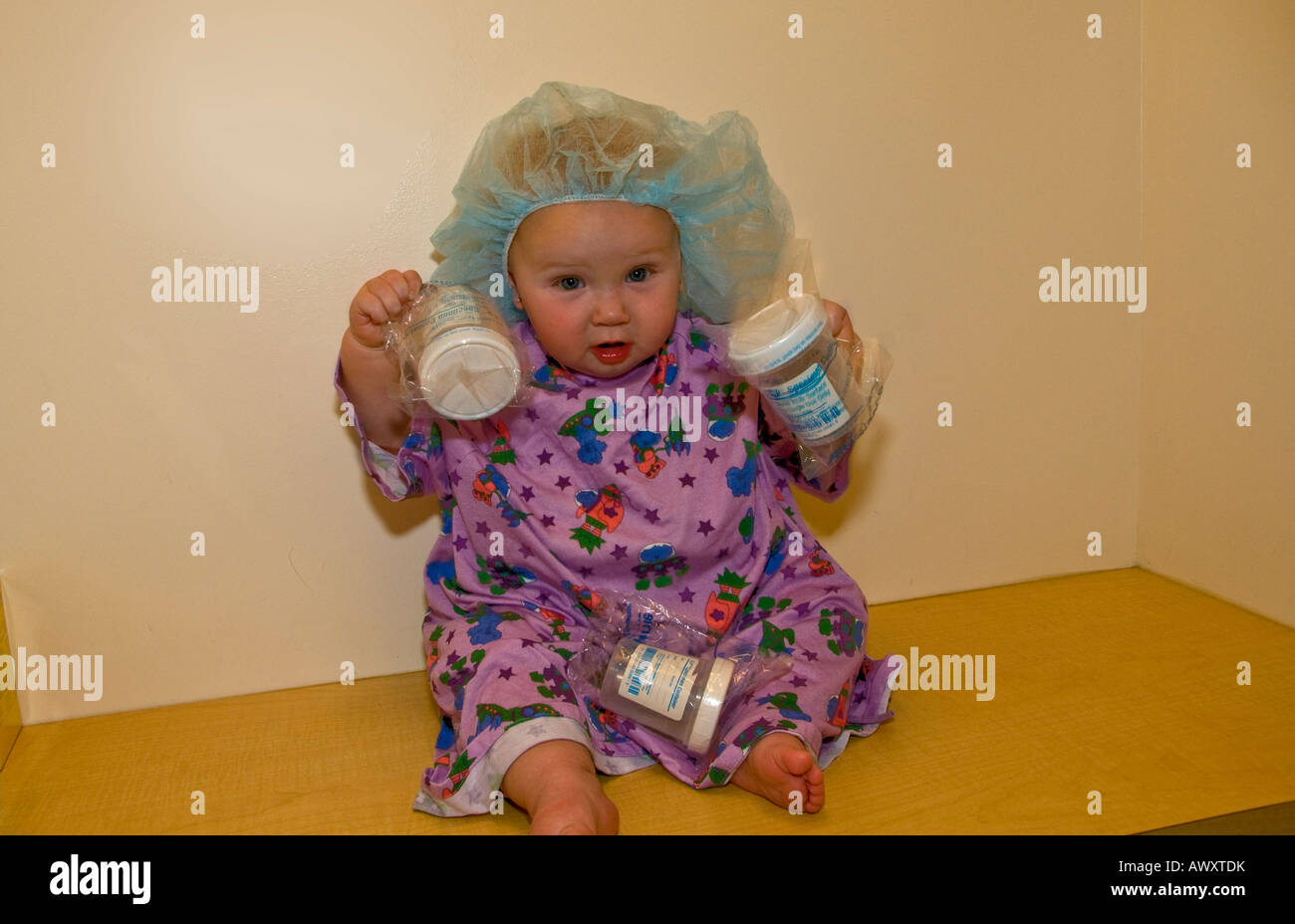 Baby Patient Shaking Specimen Cups Stock Photo